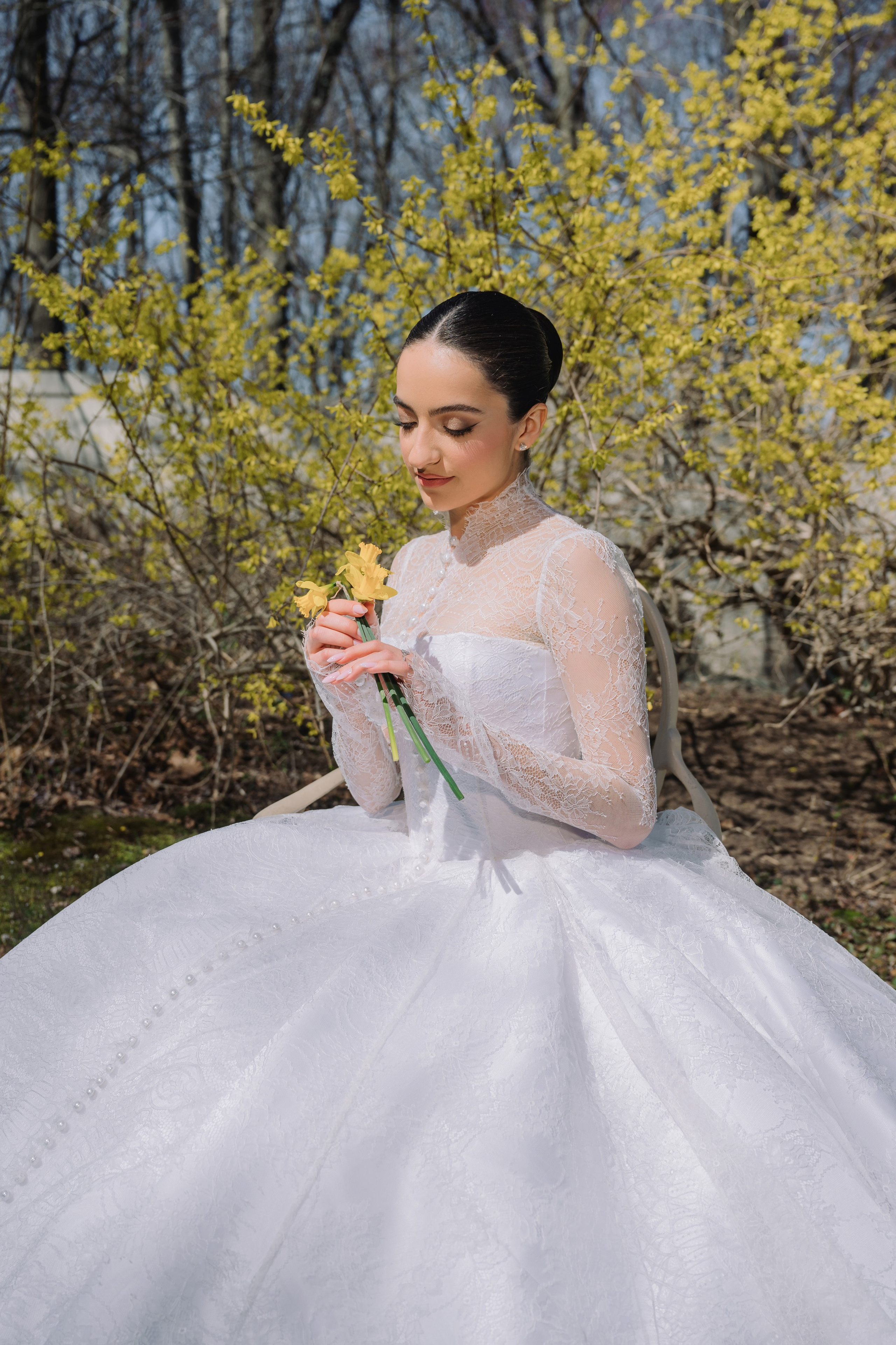 a woman in a white wedding dress holding a flower