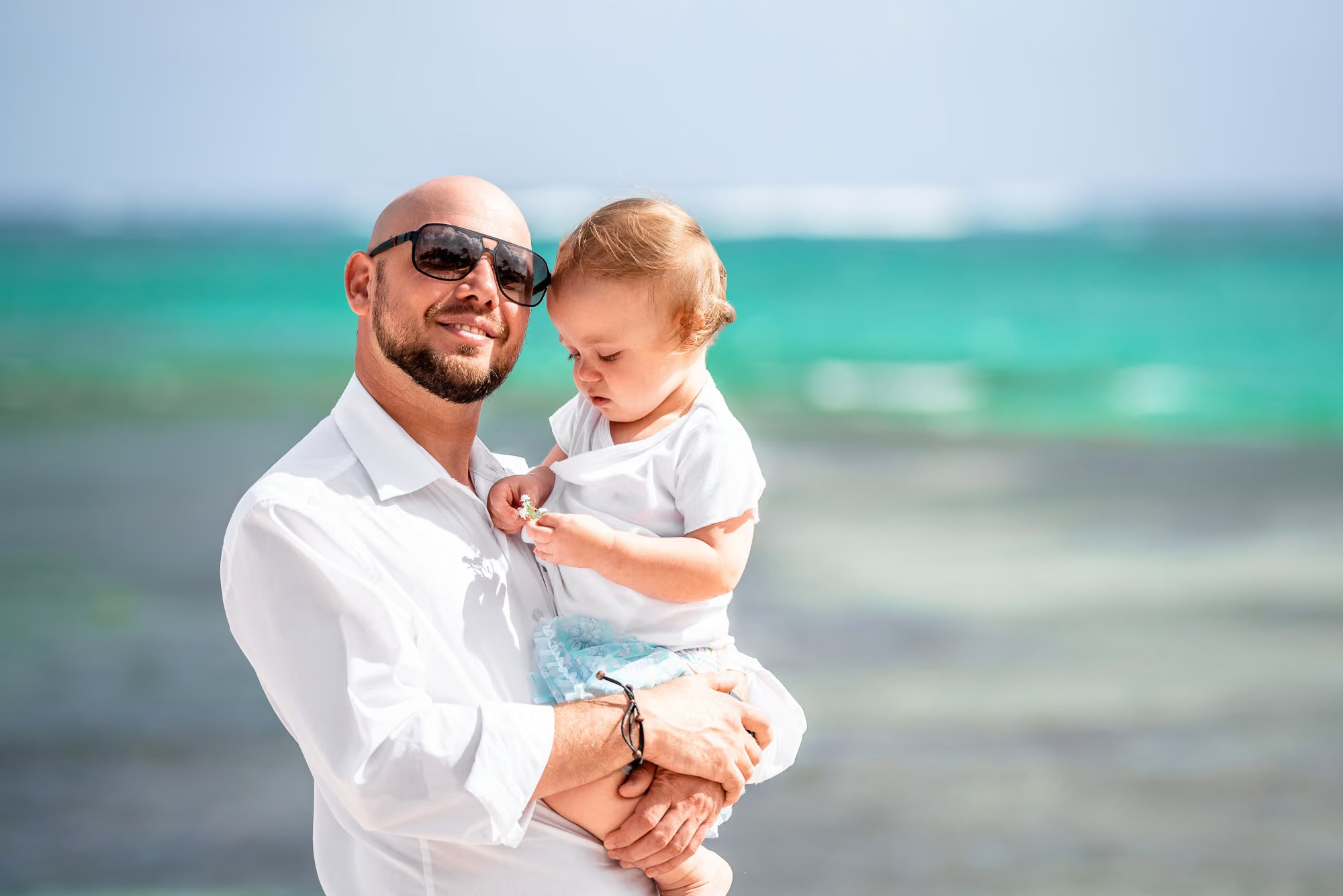 Dominican photographer capturing candid family moments on a Punta Cana beach.