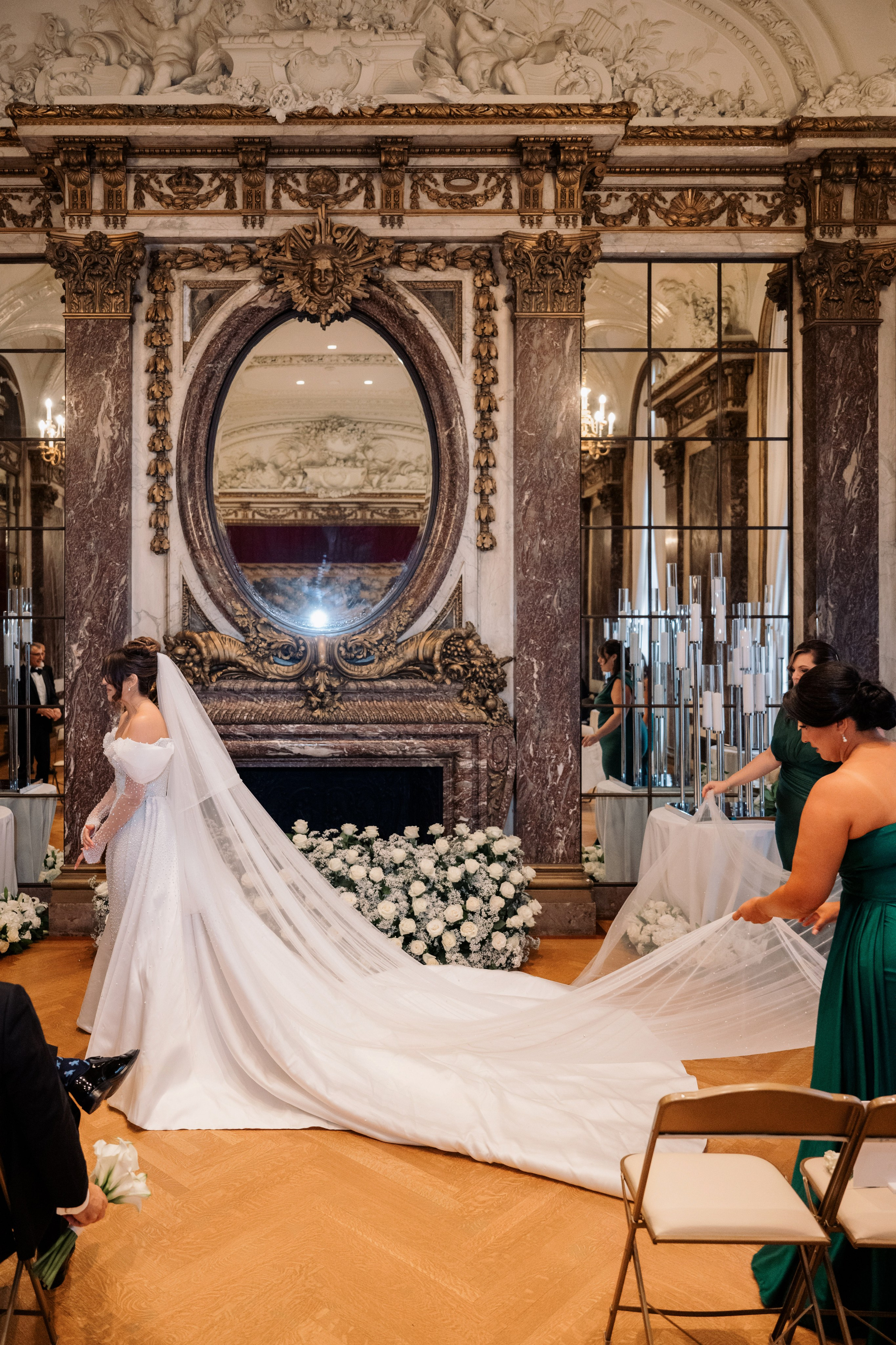 a bride is putting her veil on the groom