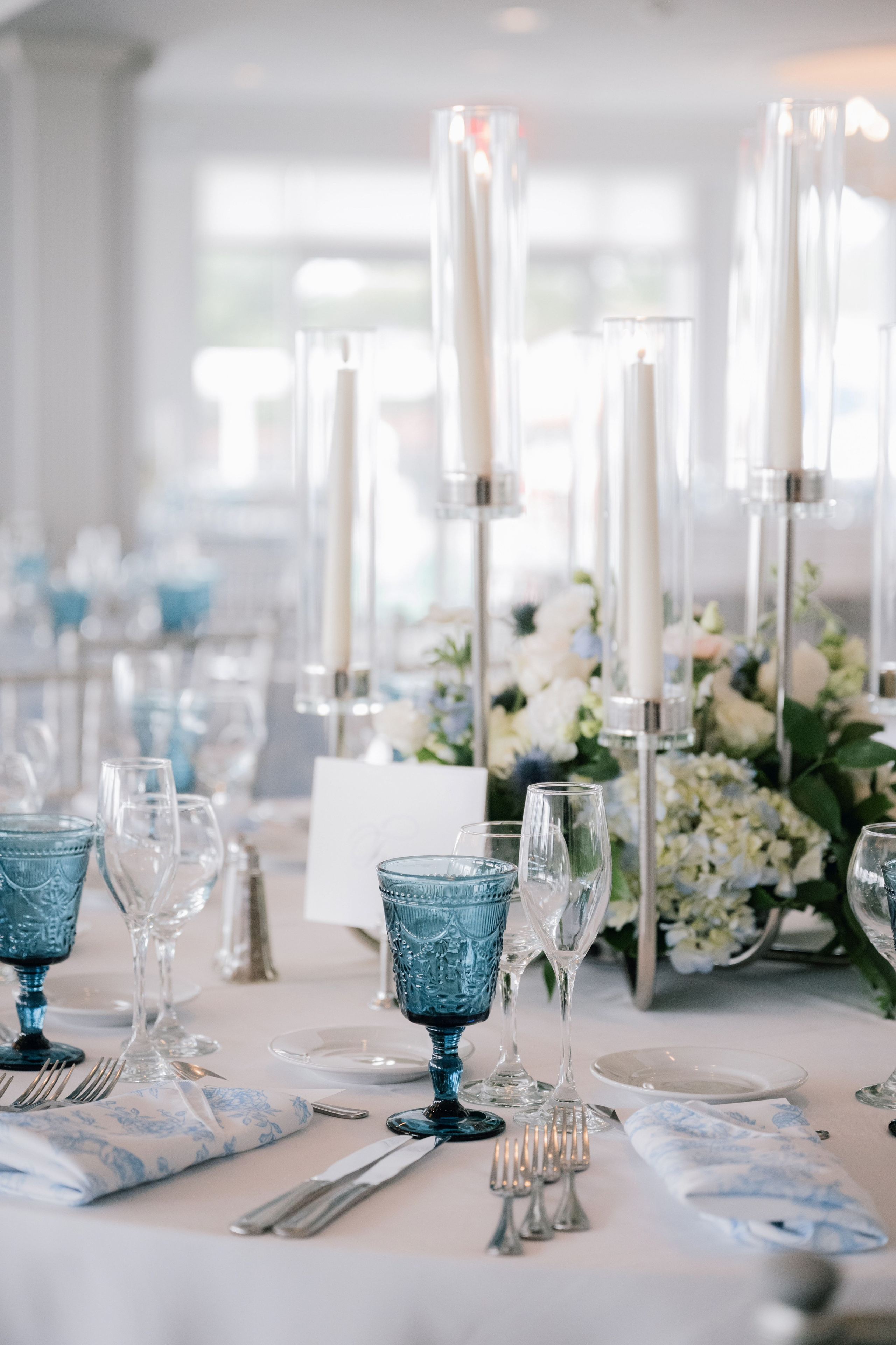 a table with a bunch of flowers and candles