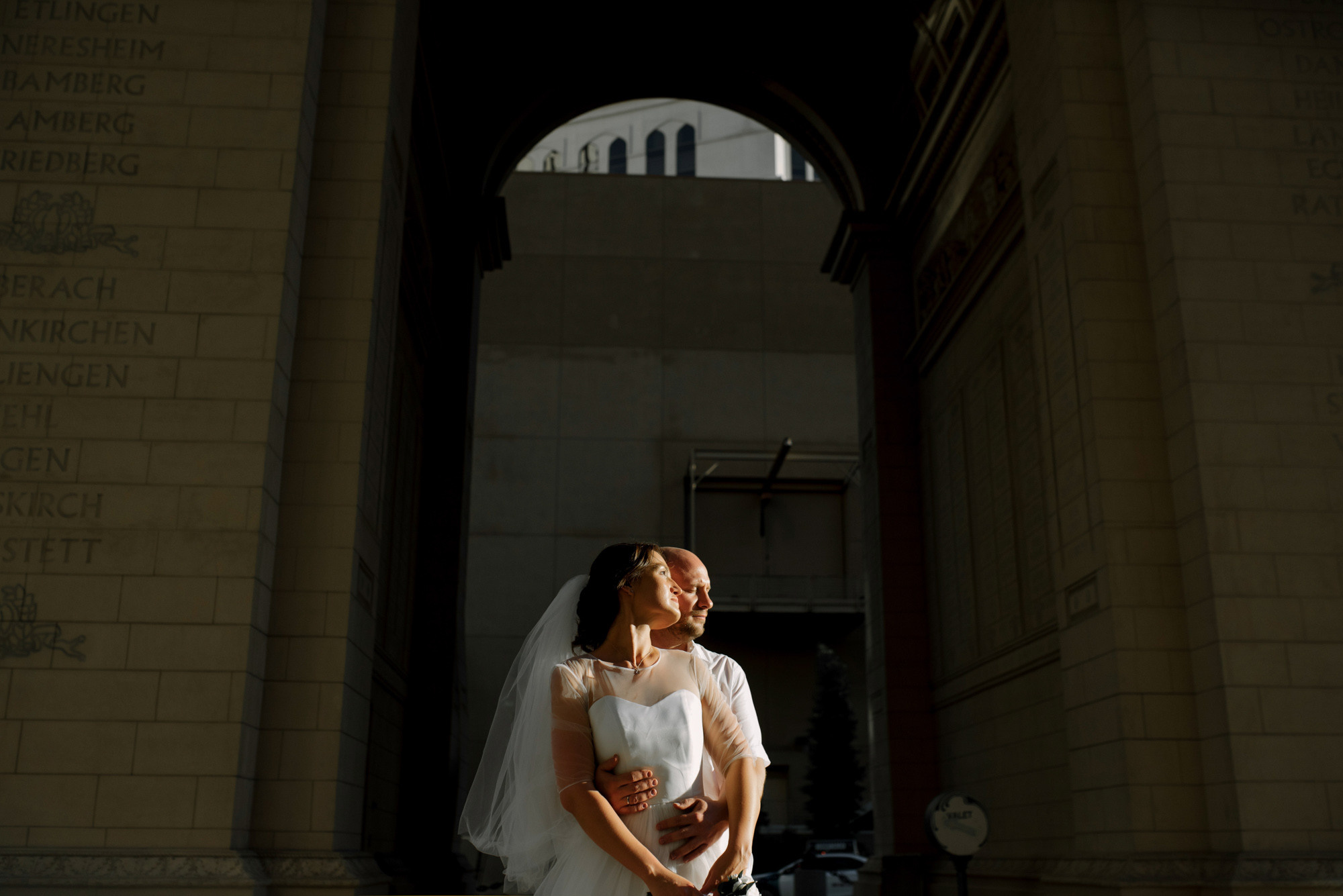 a bride and groom standing in front of a building