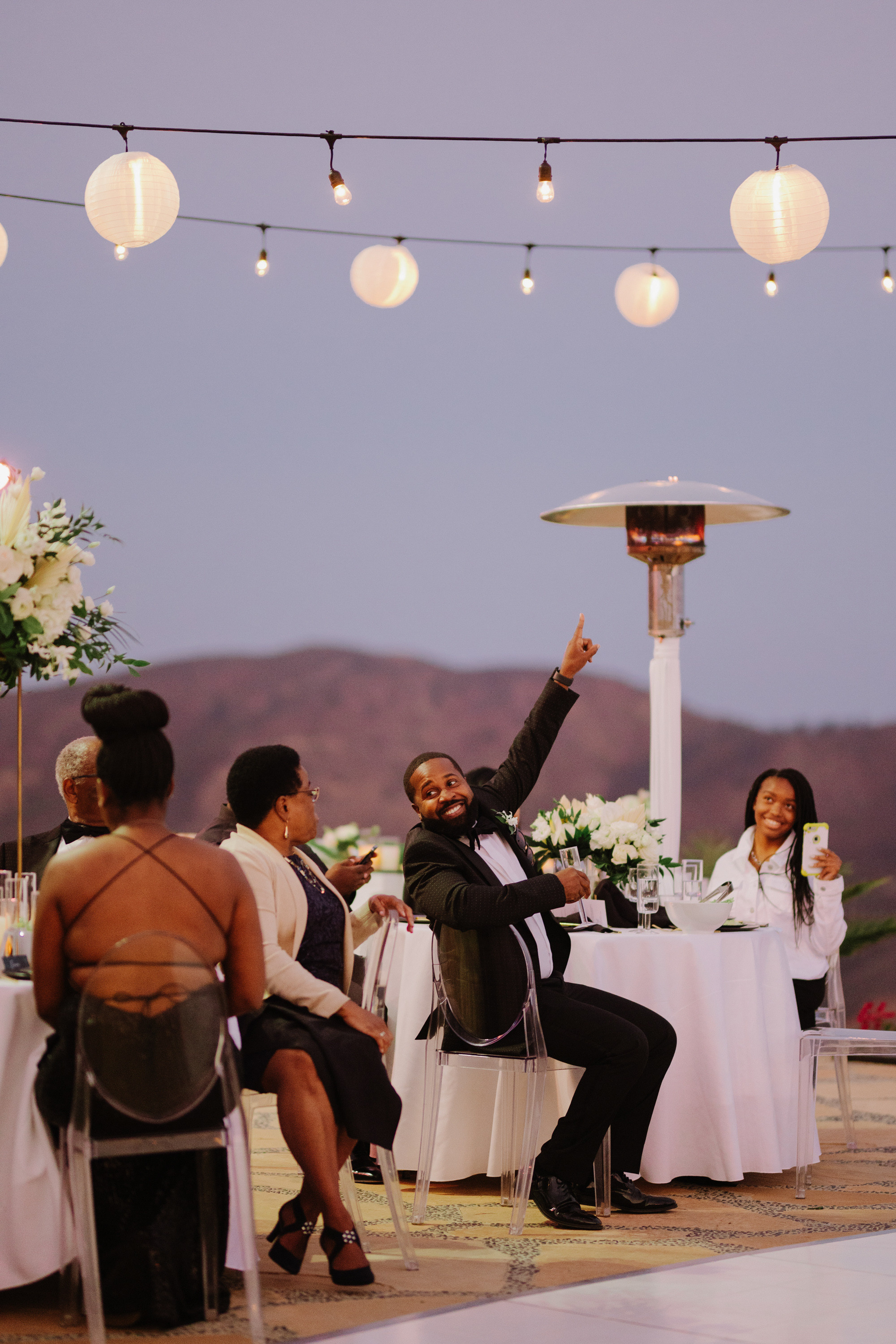 a man is throwing a paper lantern at a wedding reception