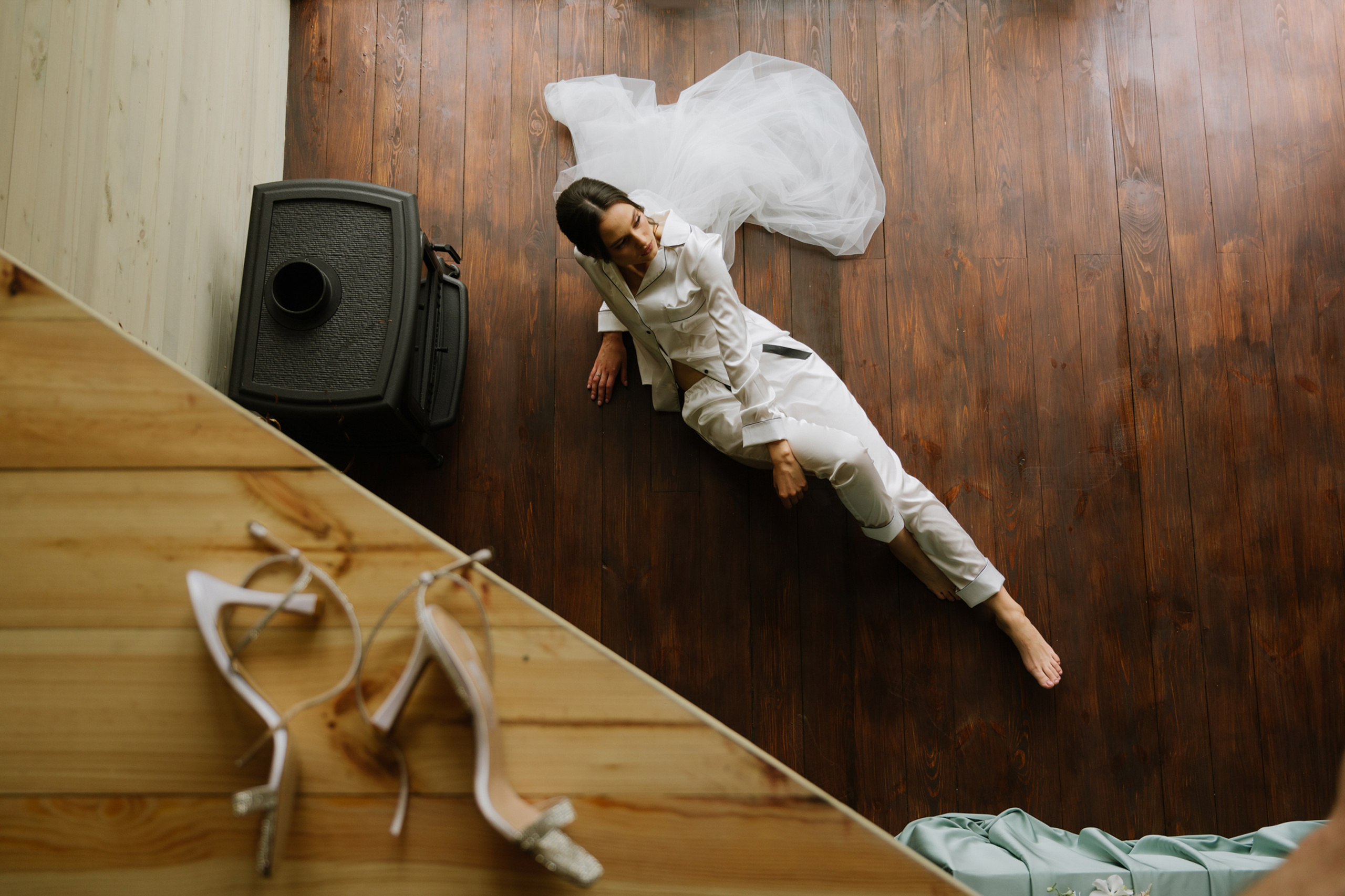 a bride laying on the floor with her shoes on