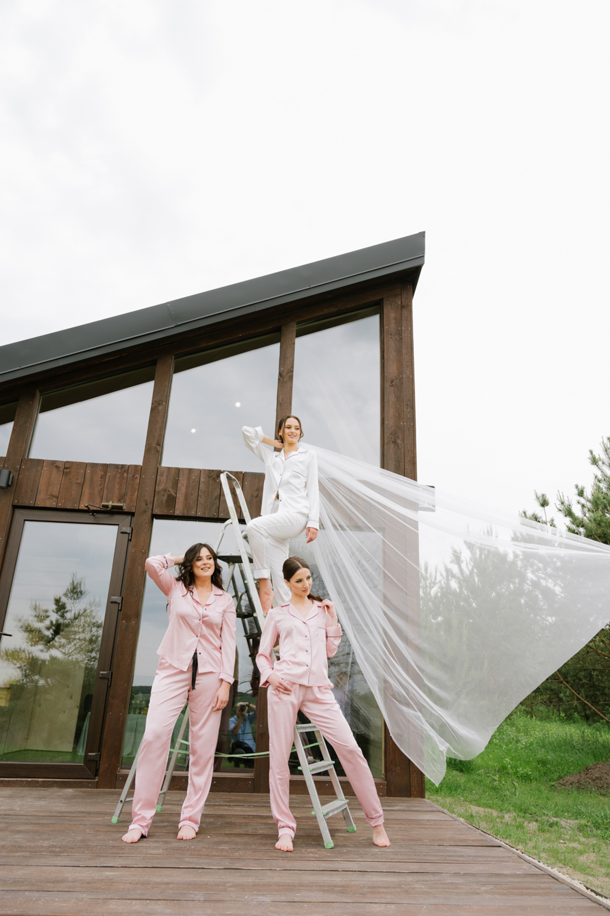 a woman in pink pajamas and a woman in white shirt