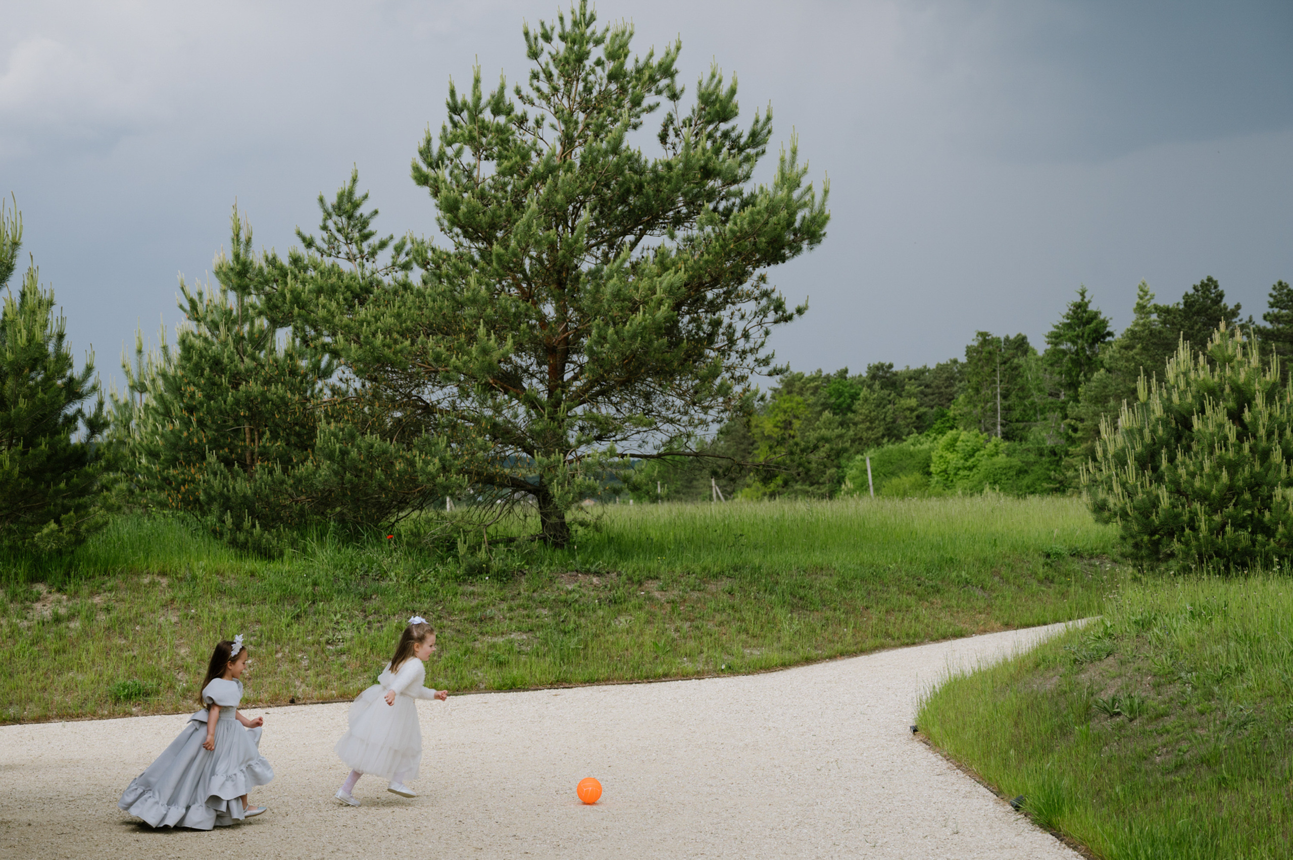 a couple of young girls playing with a ball