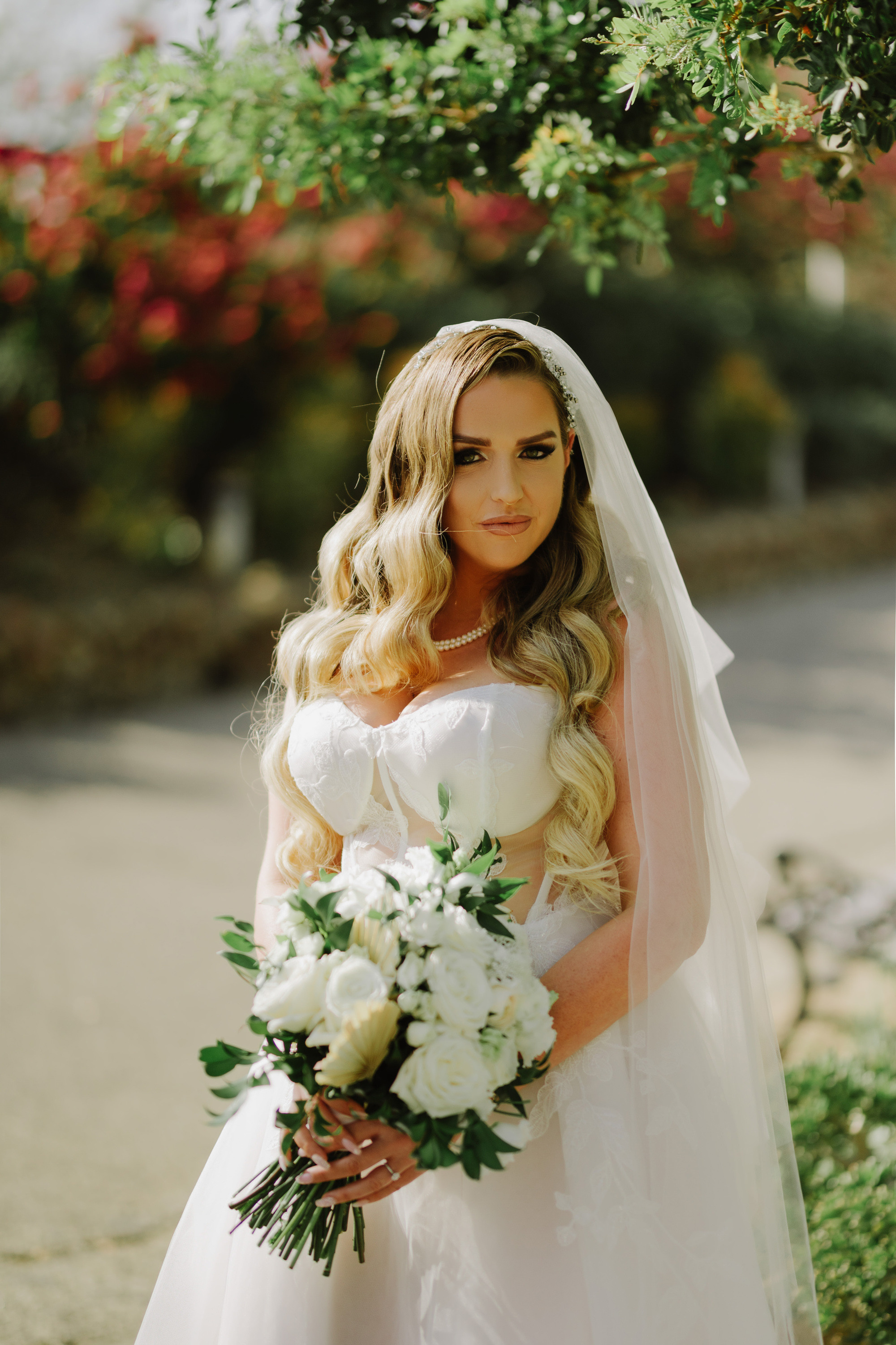 a bride in a white wedding dress holding a bouquet