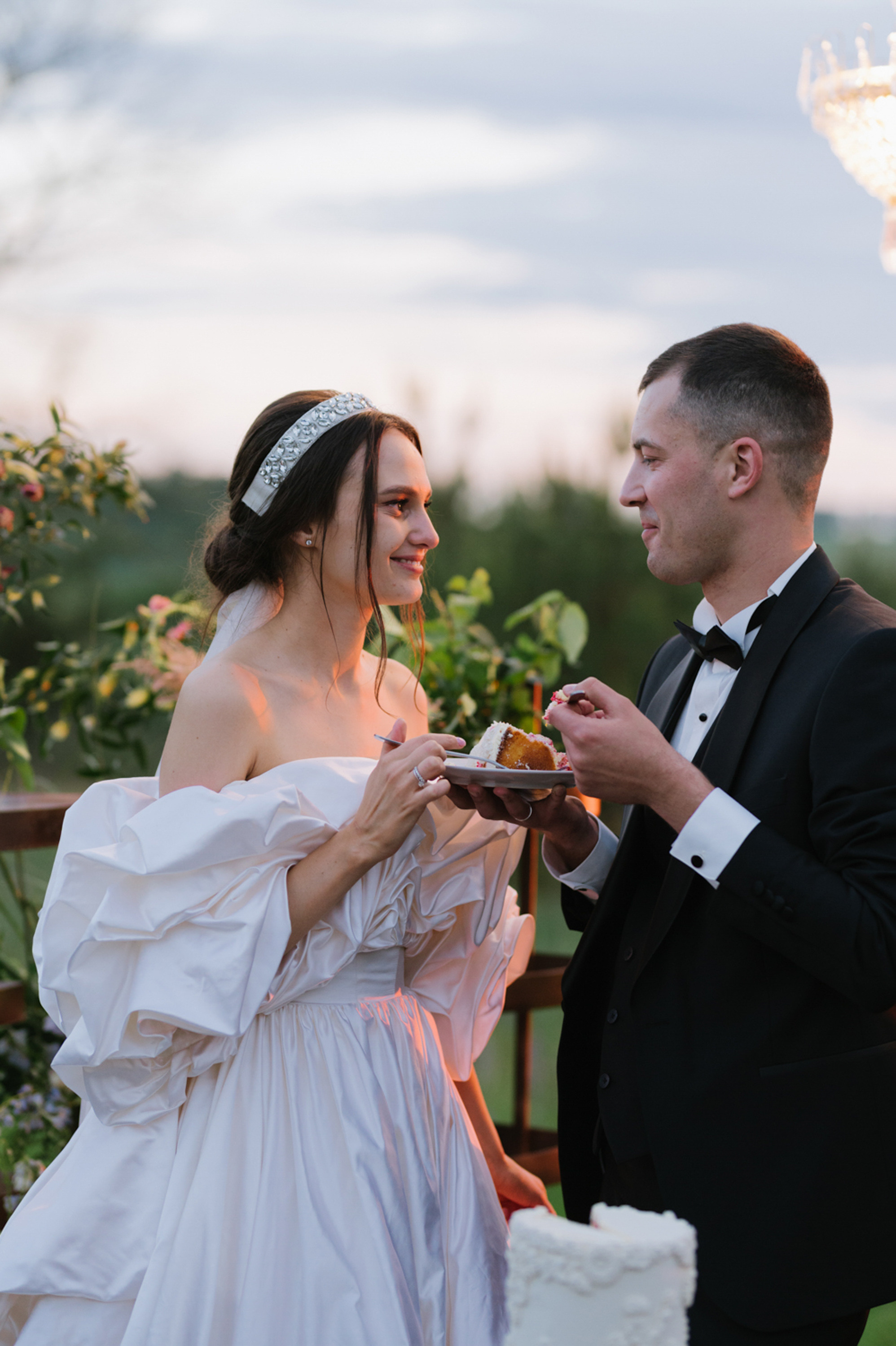 a man and woman are eating a cake