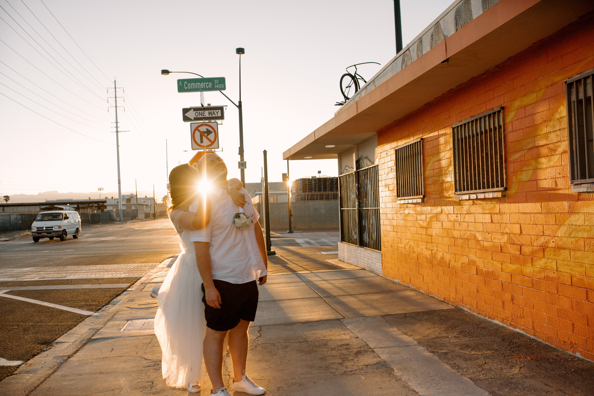 a woman in a white dress walking down a street