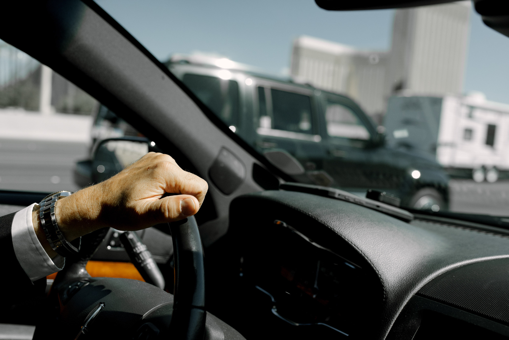 a man in a car holding a steering wheel