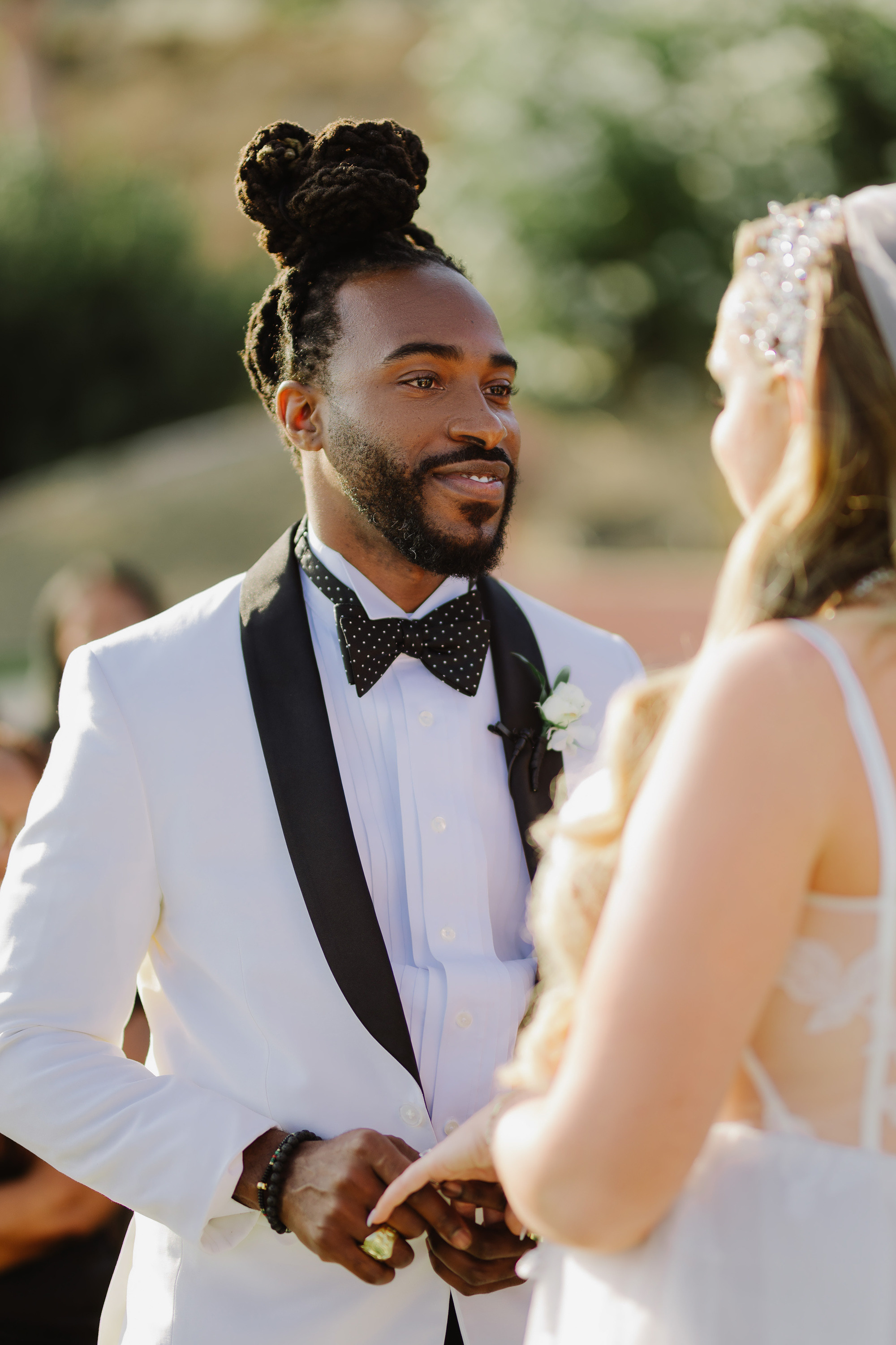 a man in a white suit and bow tie