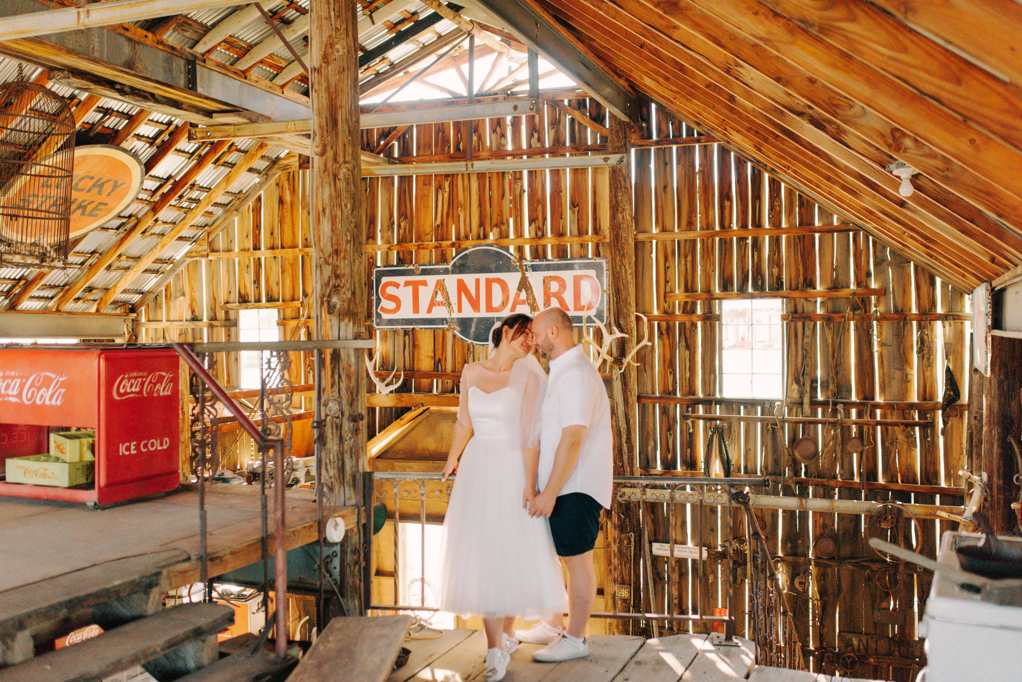 a bride and groom in a barn