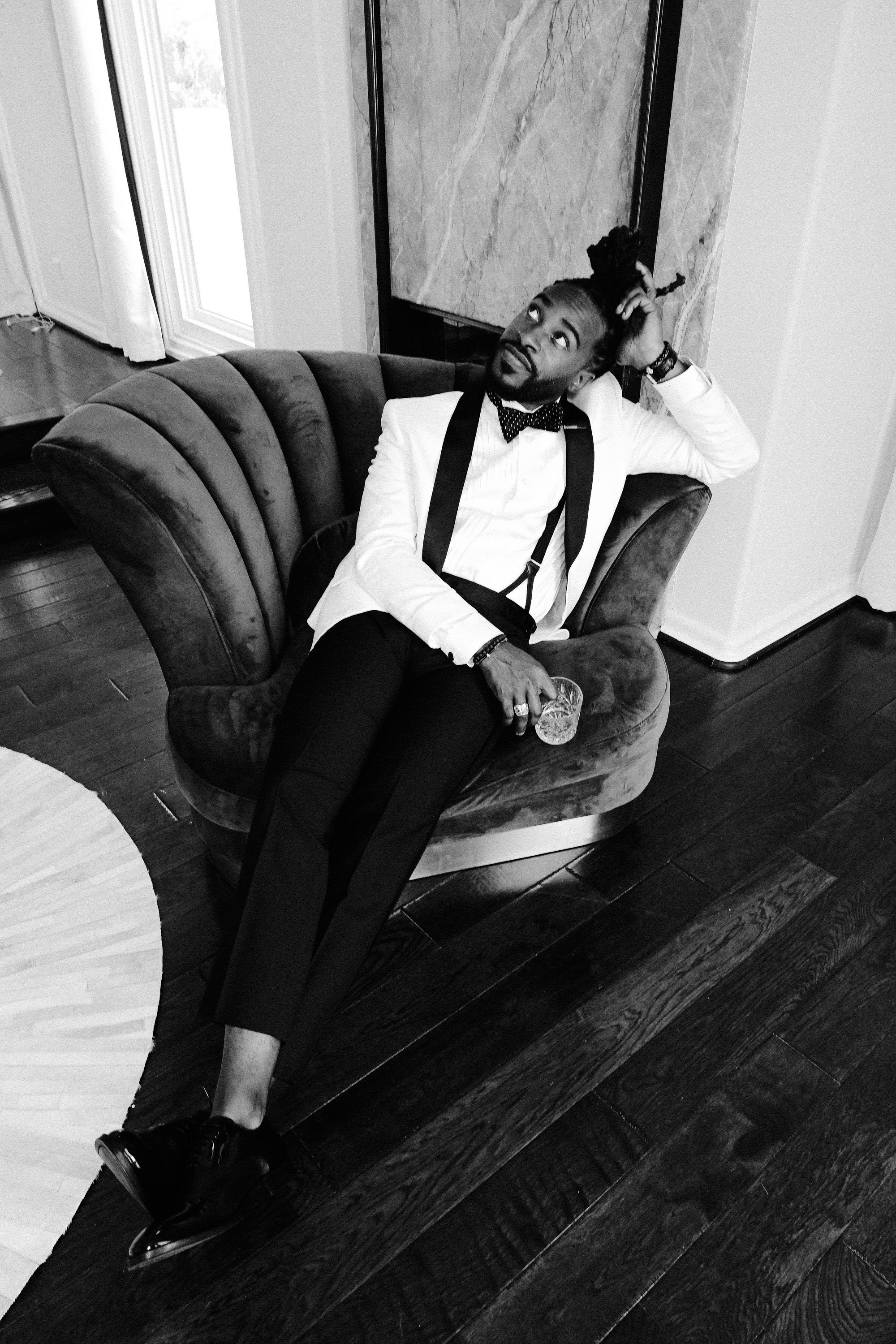 a man in a suit sitting on a couch