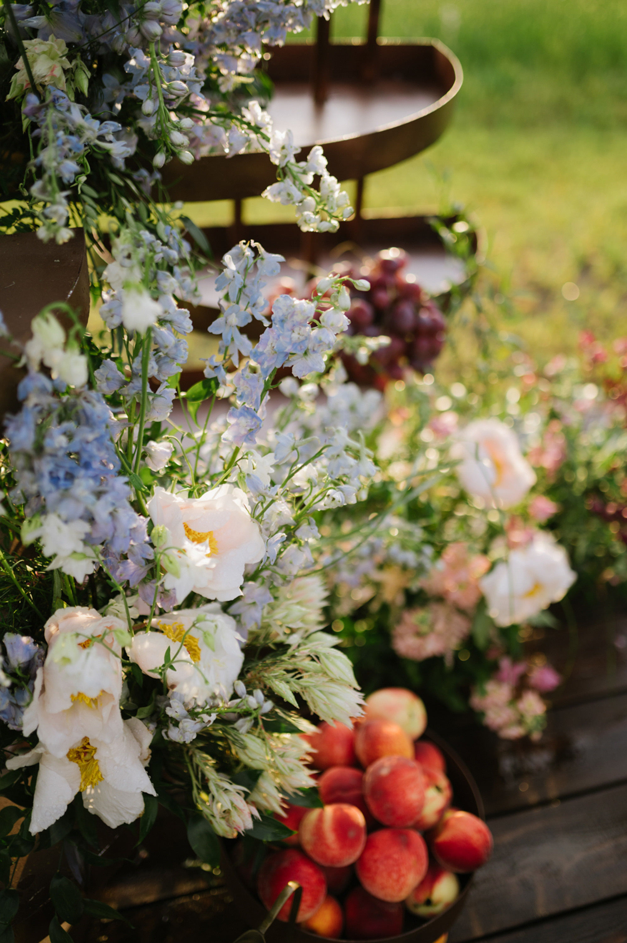 a bunch of flowers and apples on a table