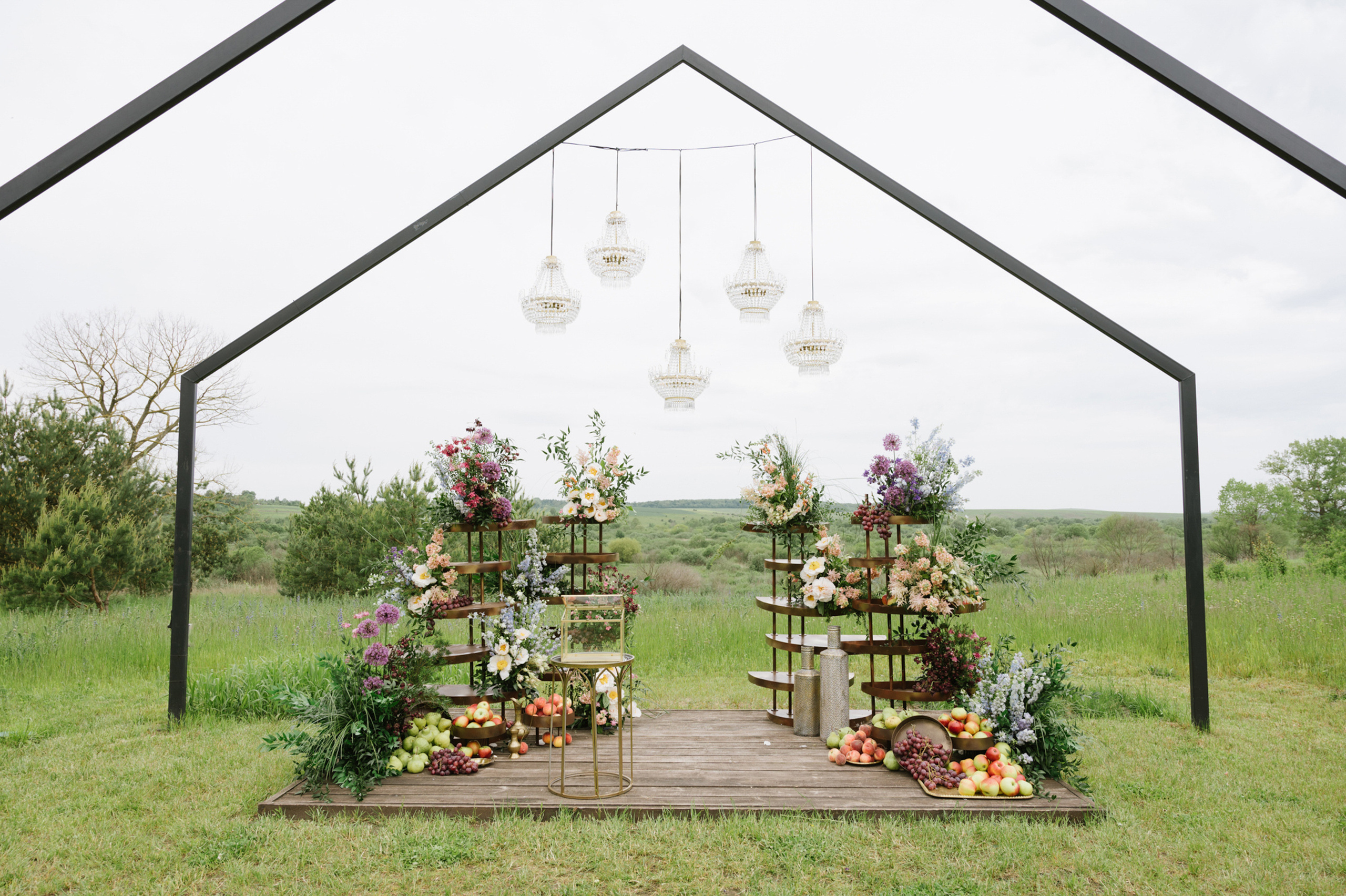 a wooden table with flowers and fruit on it