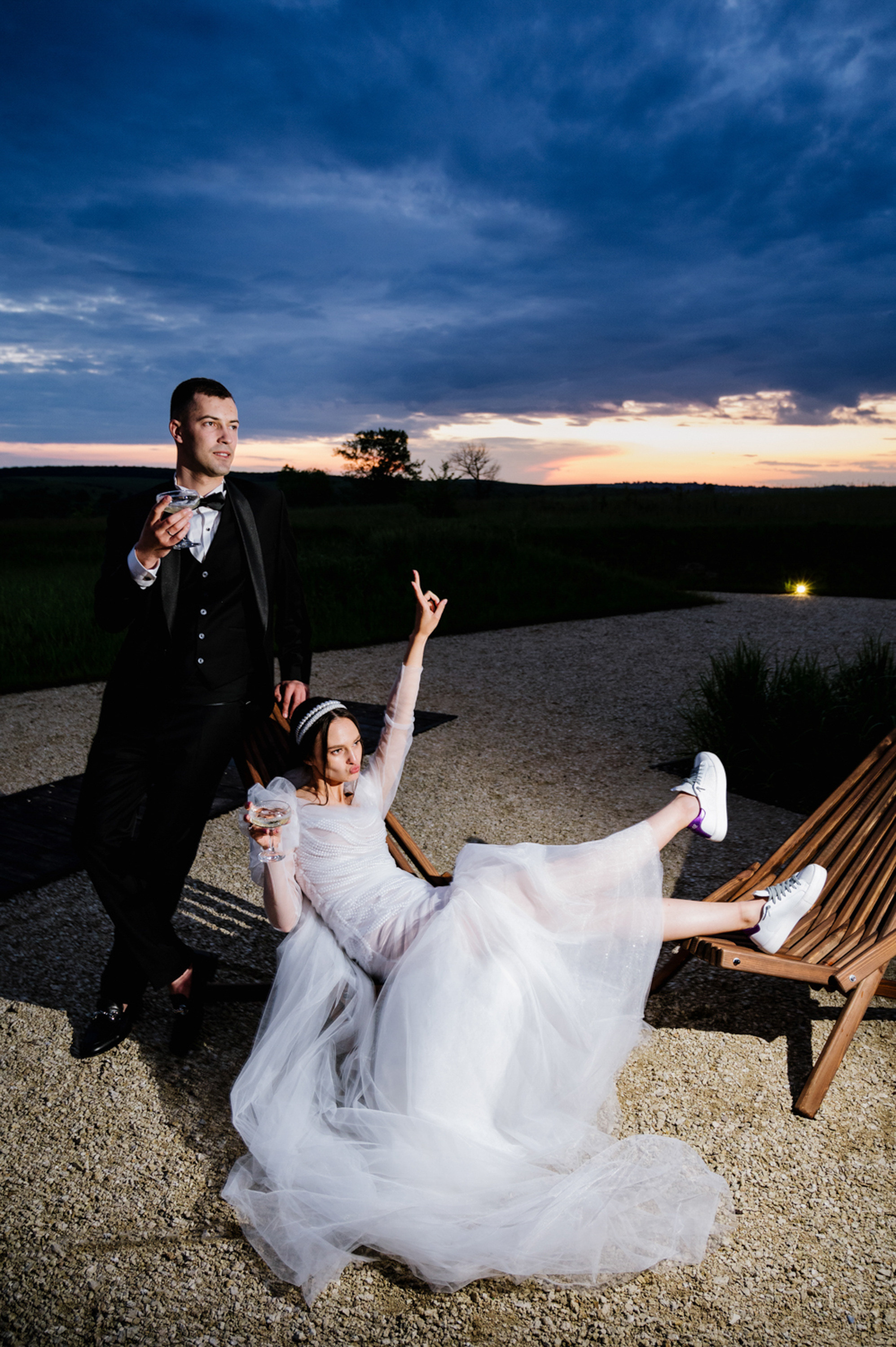 a bride and groom sitting on a bench