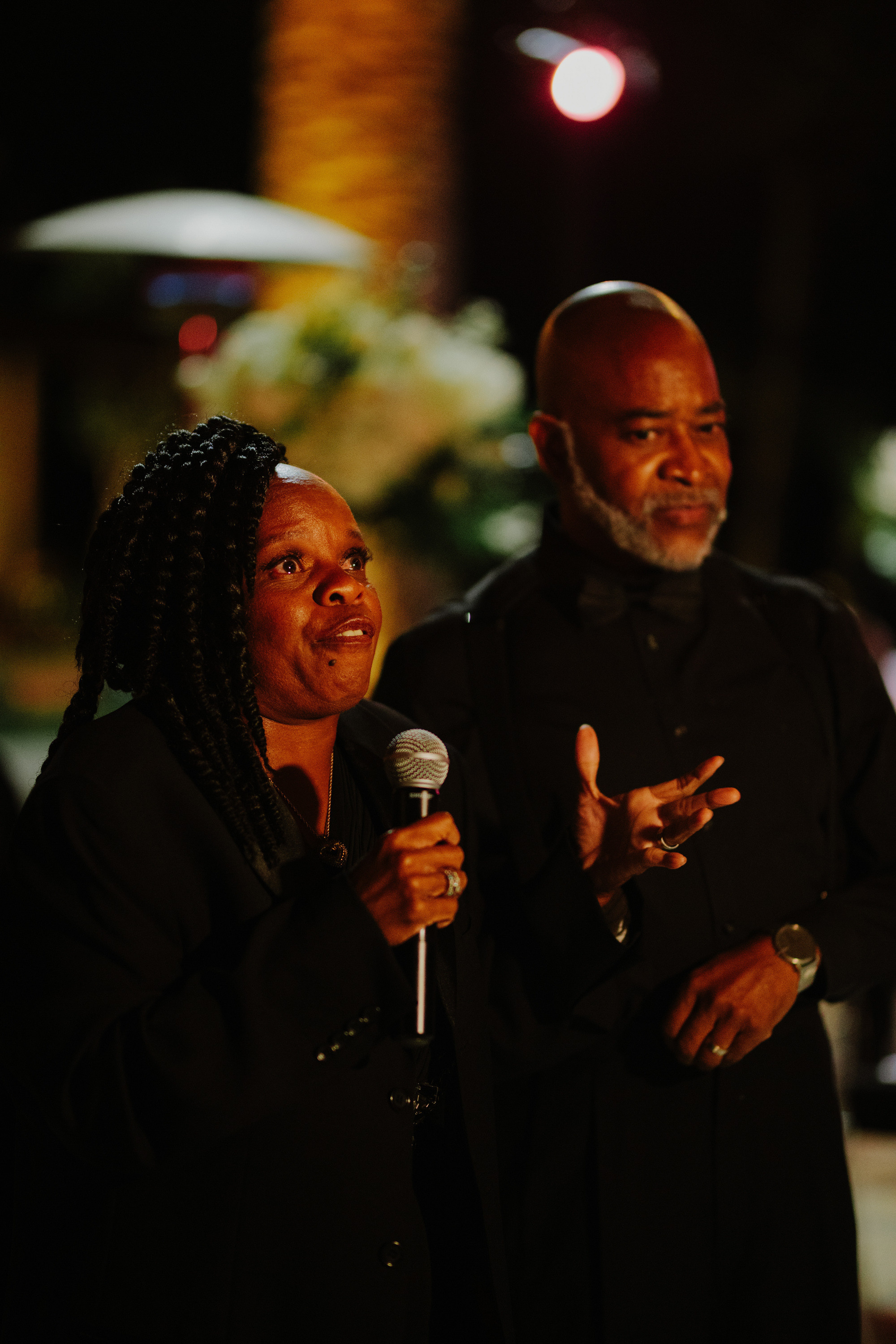 a man and woman singing into a microphone