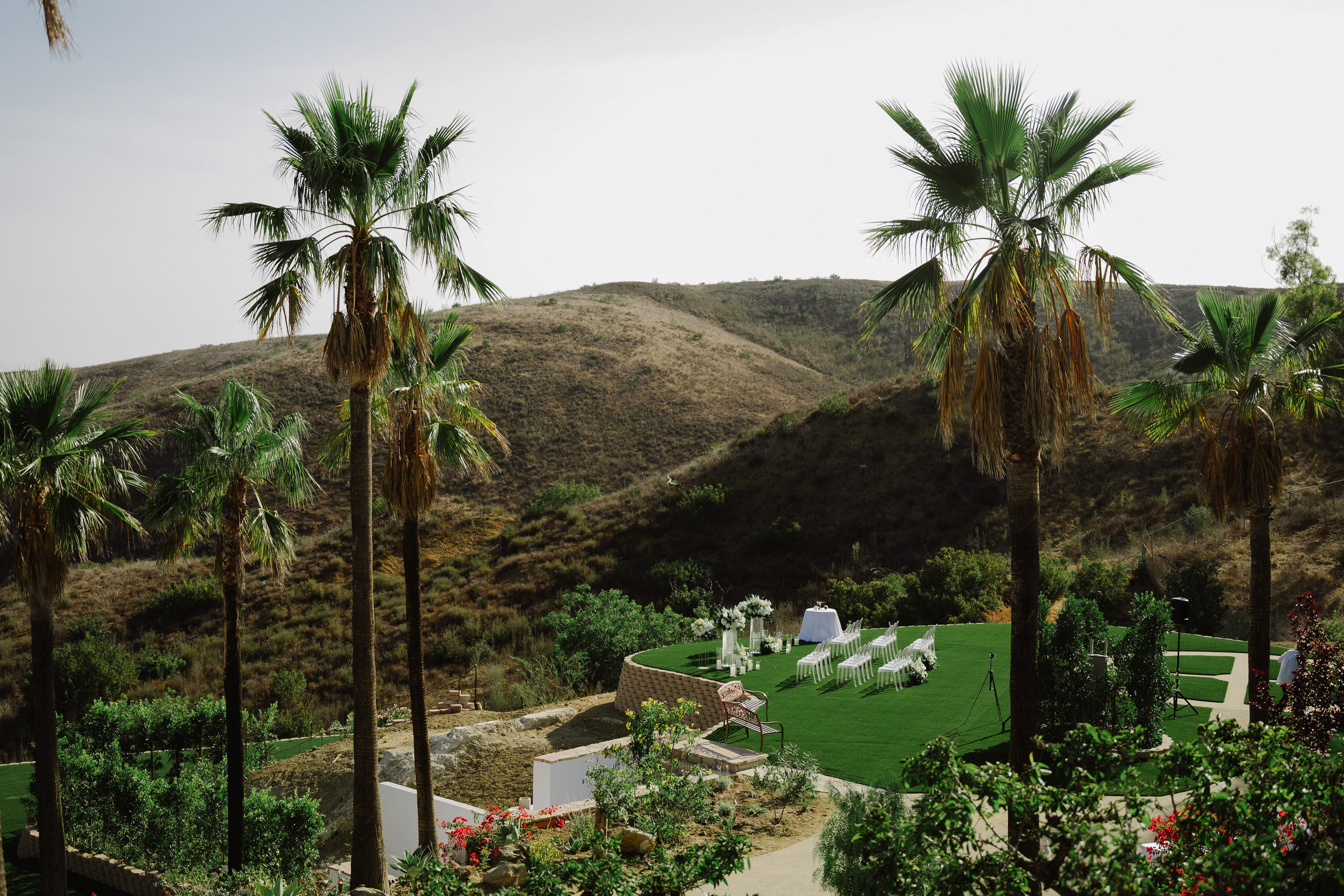 a view of a house and palm trees