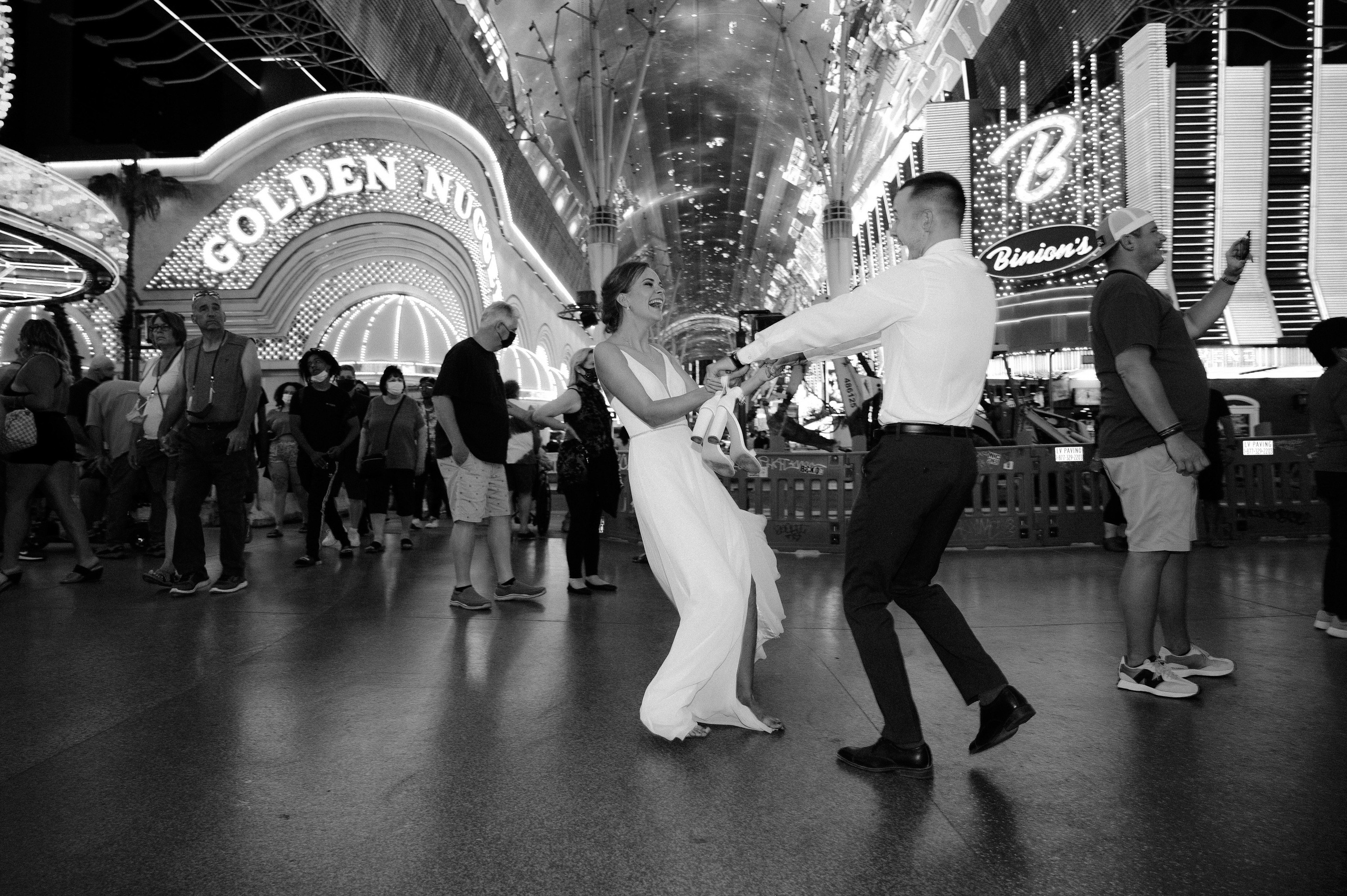 a bride and groom dancing in the middle of a city street