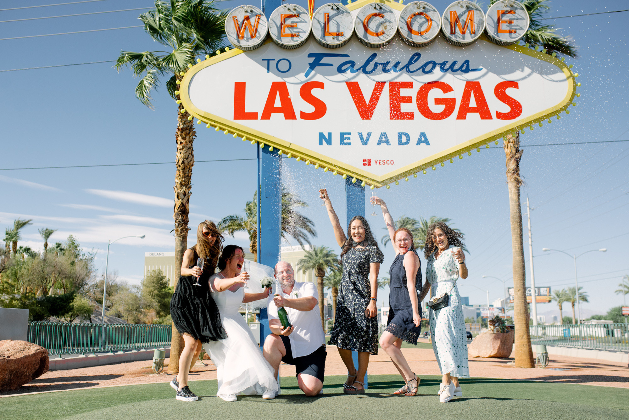 a group of women posing in front of a welcome sign