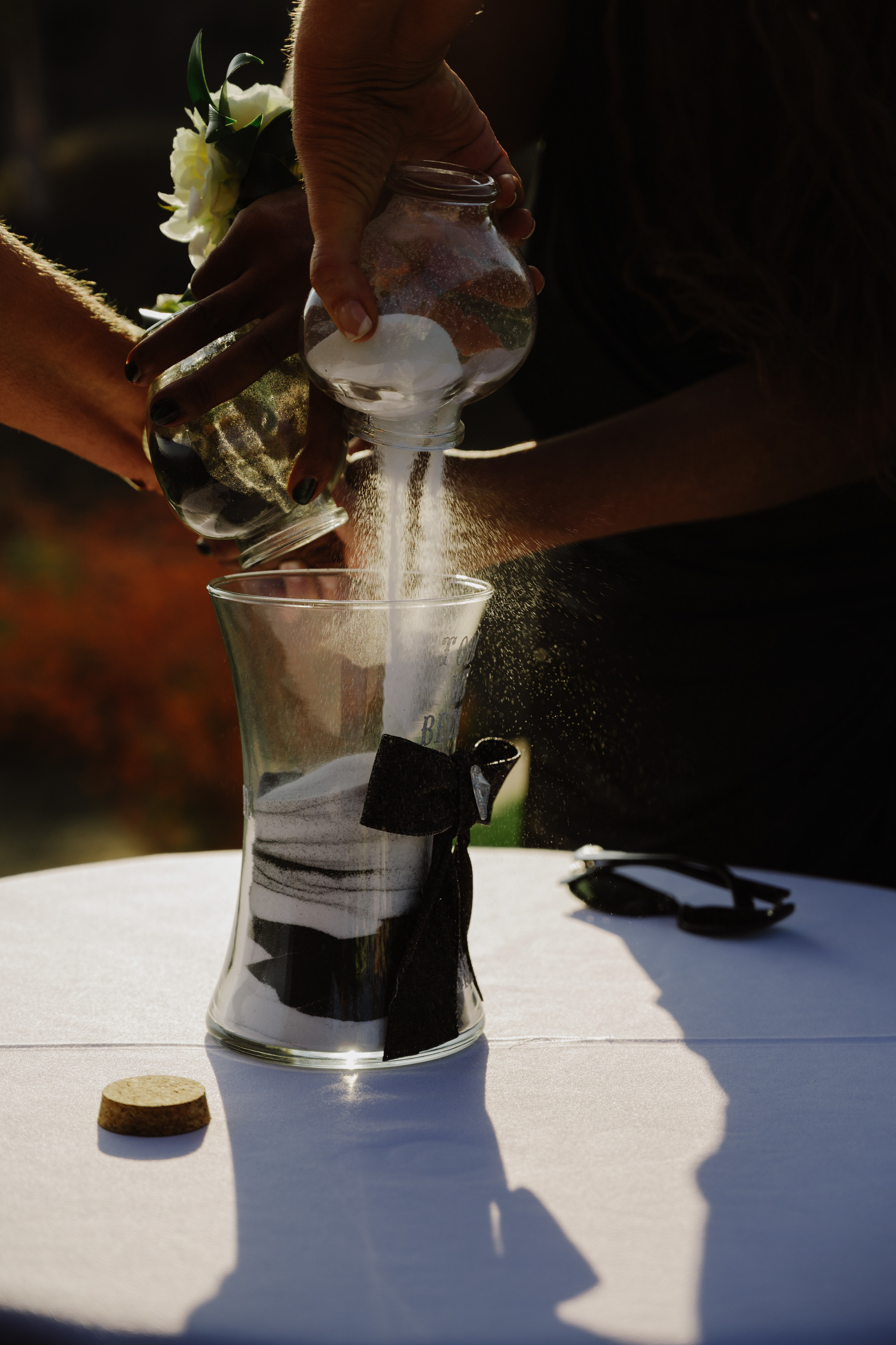 a person is pouring water into a glass