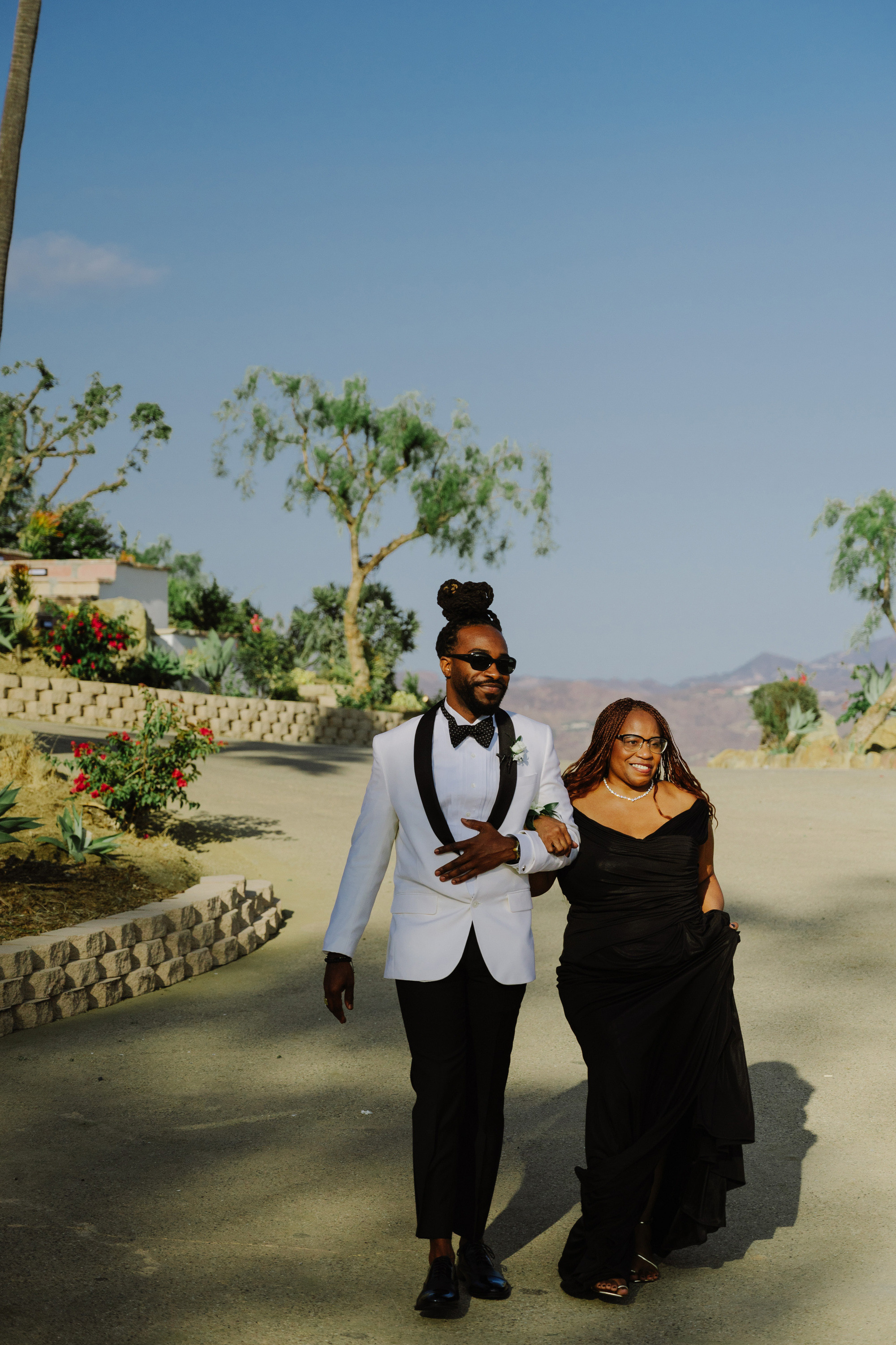 a man and woman walking down a path