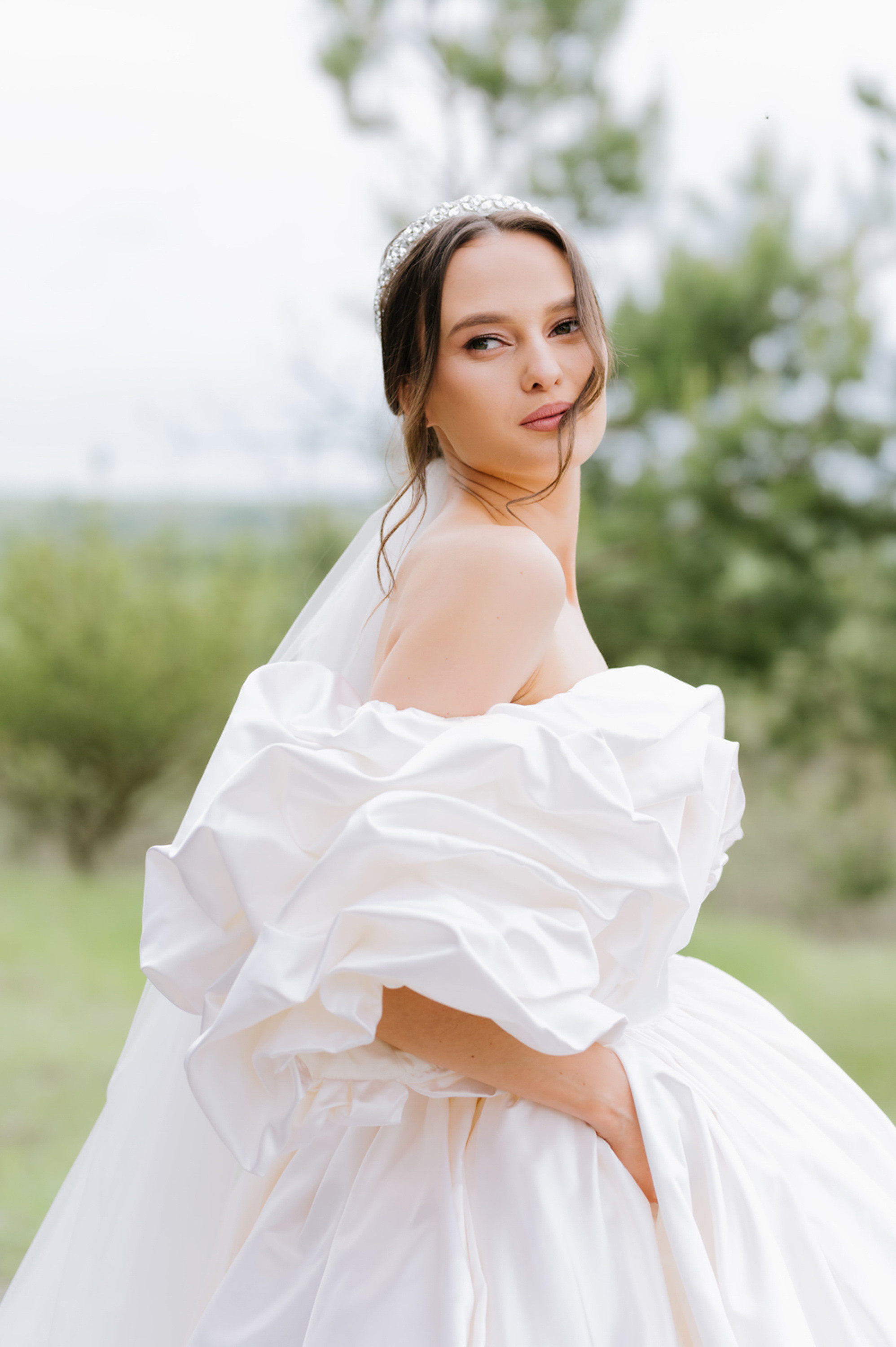 a woman in a white wedding dress posing for the camera