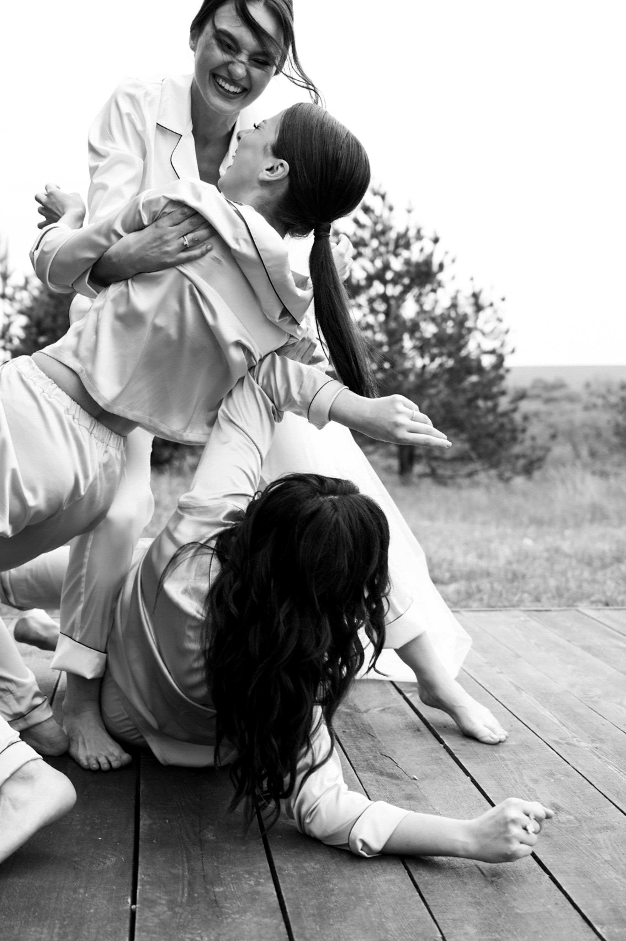 a woman is sitting on the ground with her two children