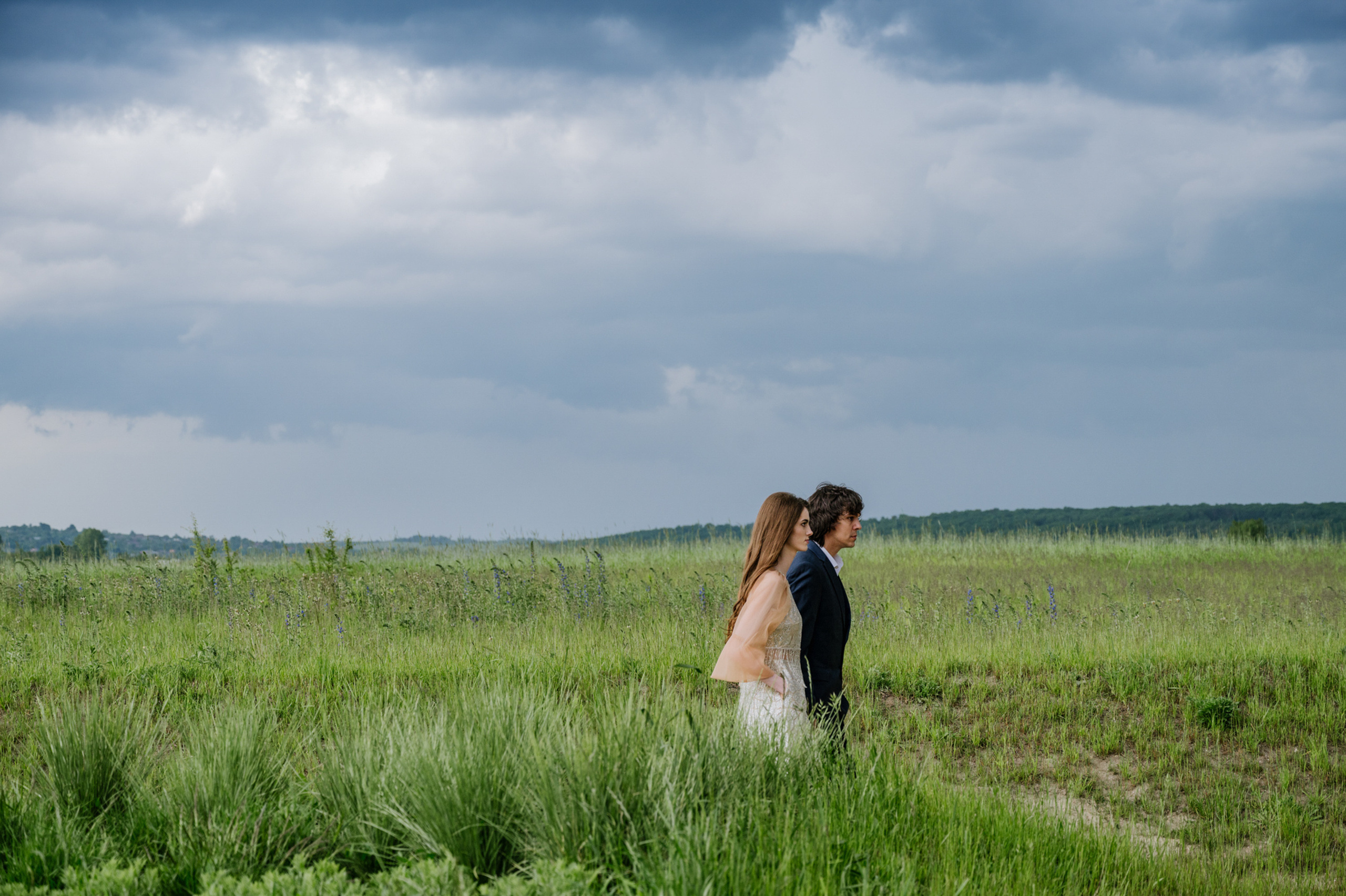 a couple standing in a field