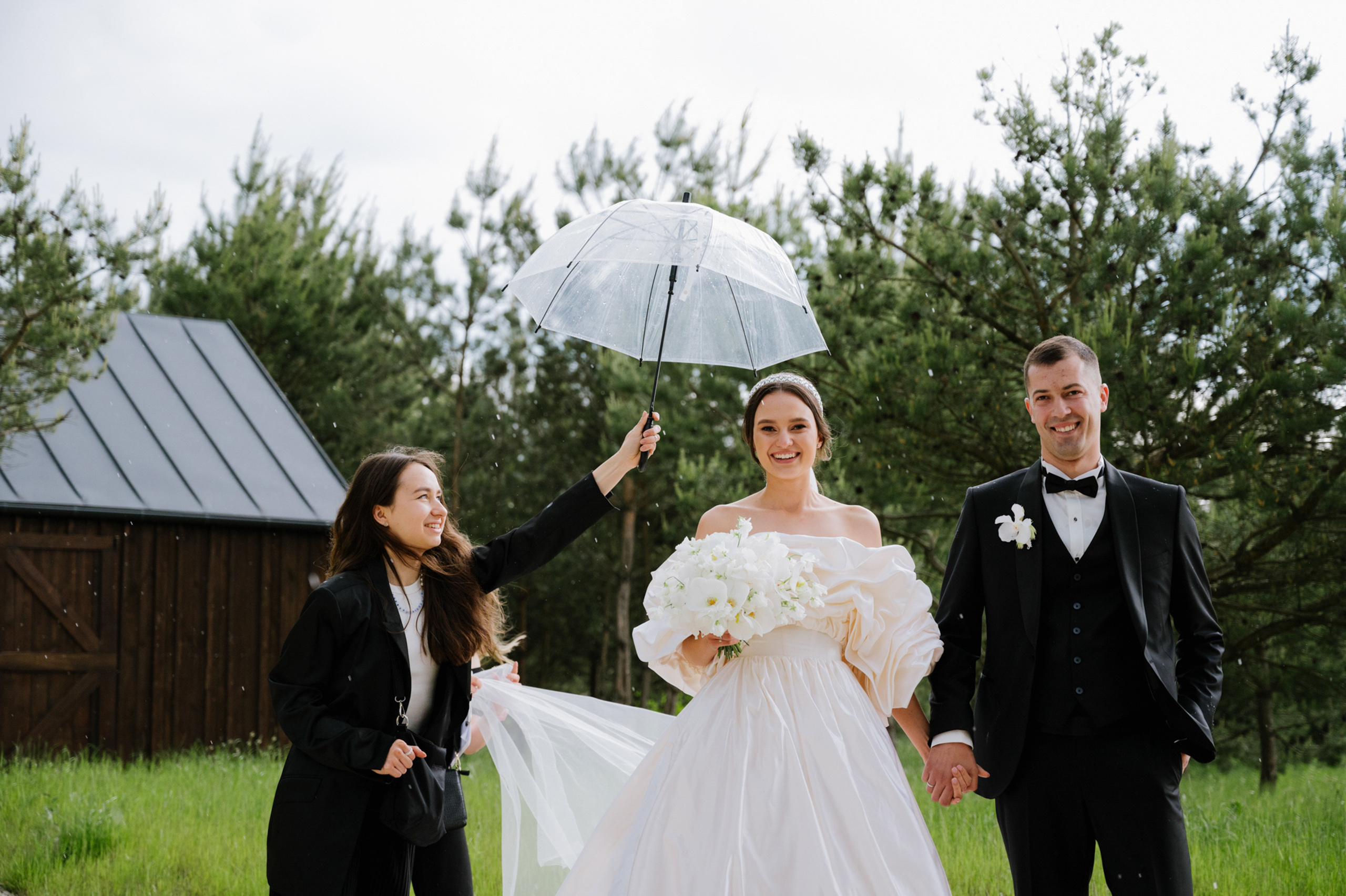a bride and groom walking in the grass
