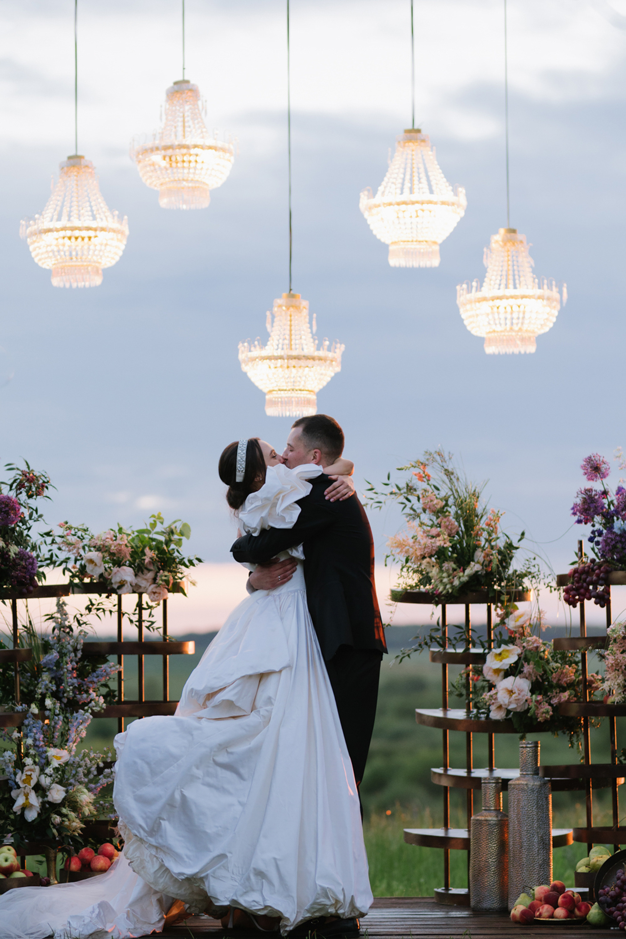 a bride and groom kissing in front of a wedding ceremony