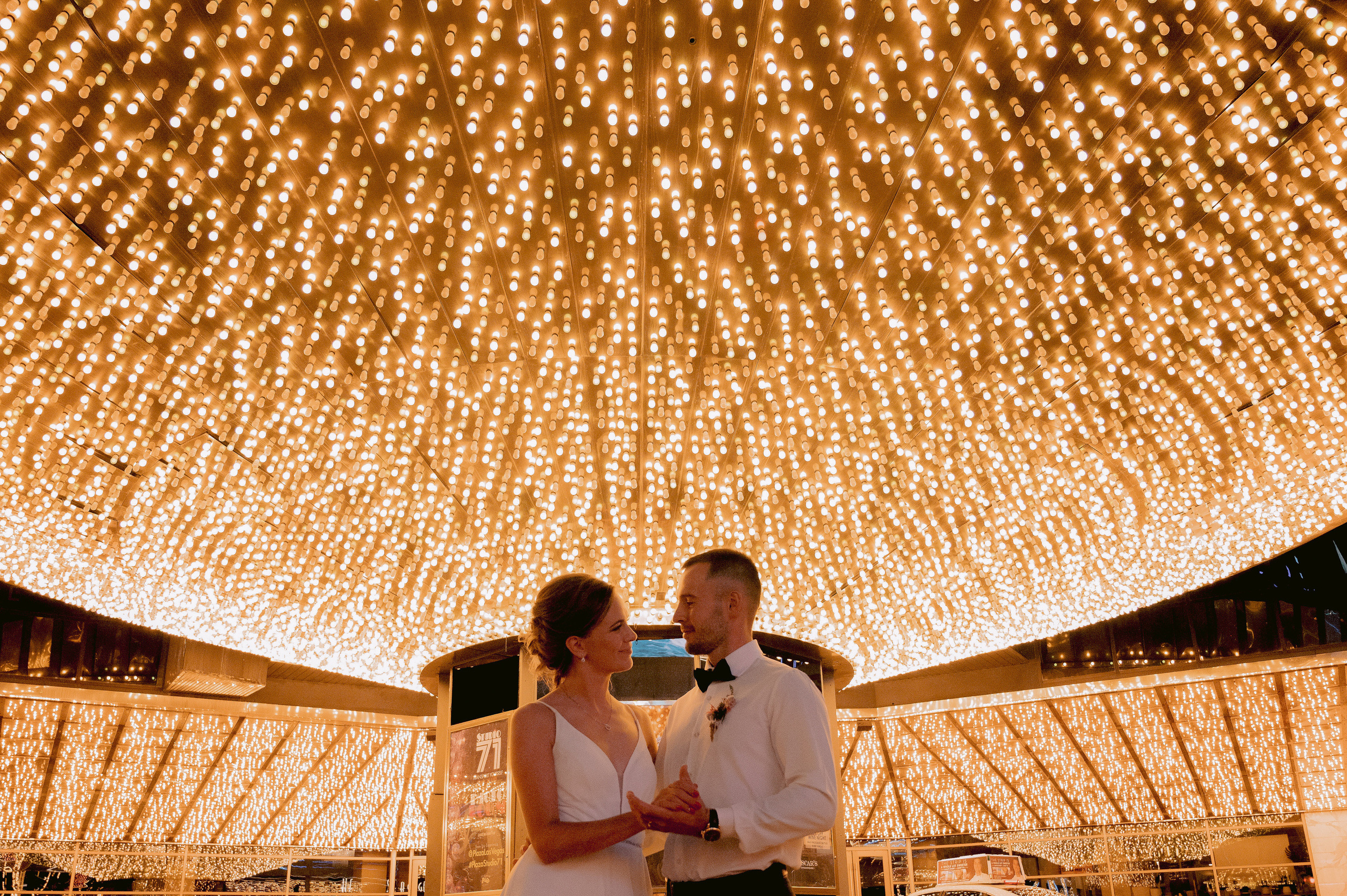 a couple standing under a large light