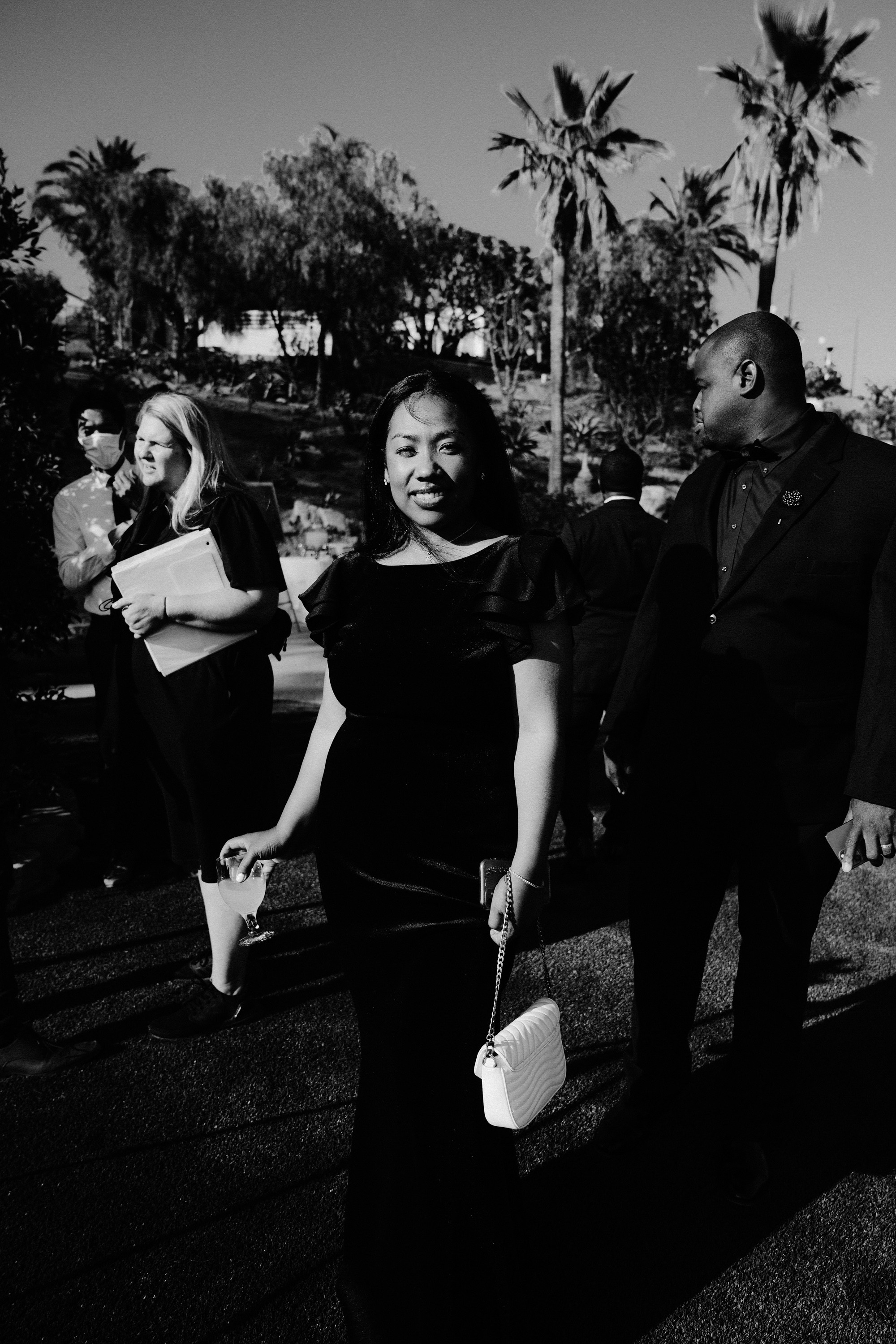 a group of people standing around a park