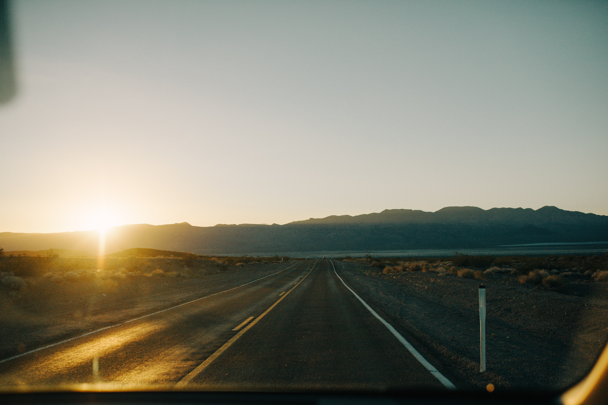 a view of a road with mountains in the distance