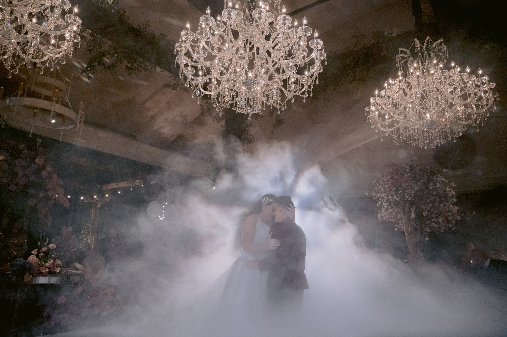 a couple dancing in a smoke filled room