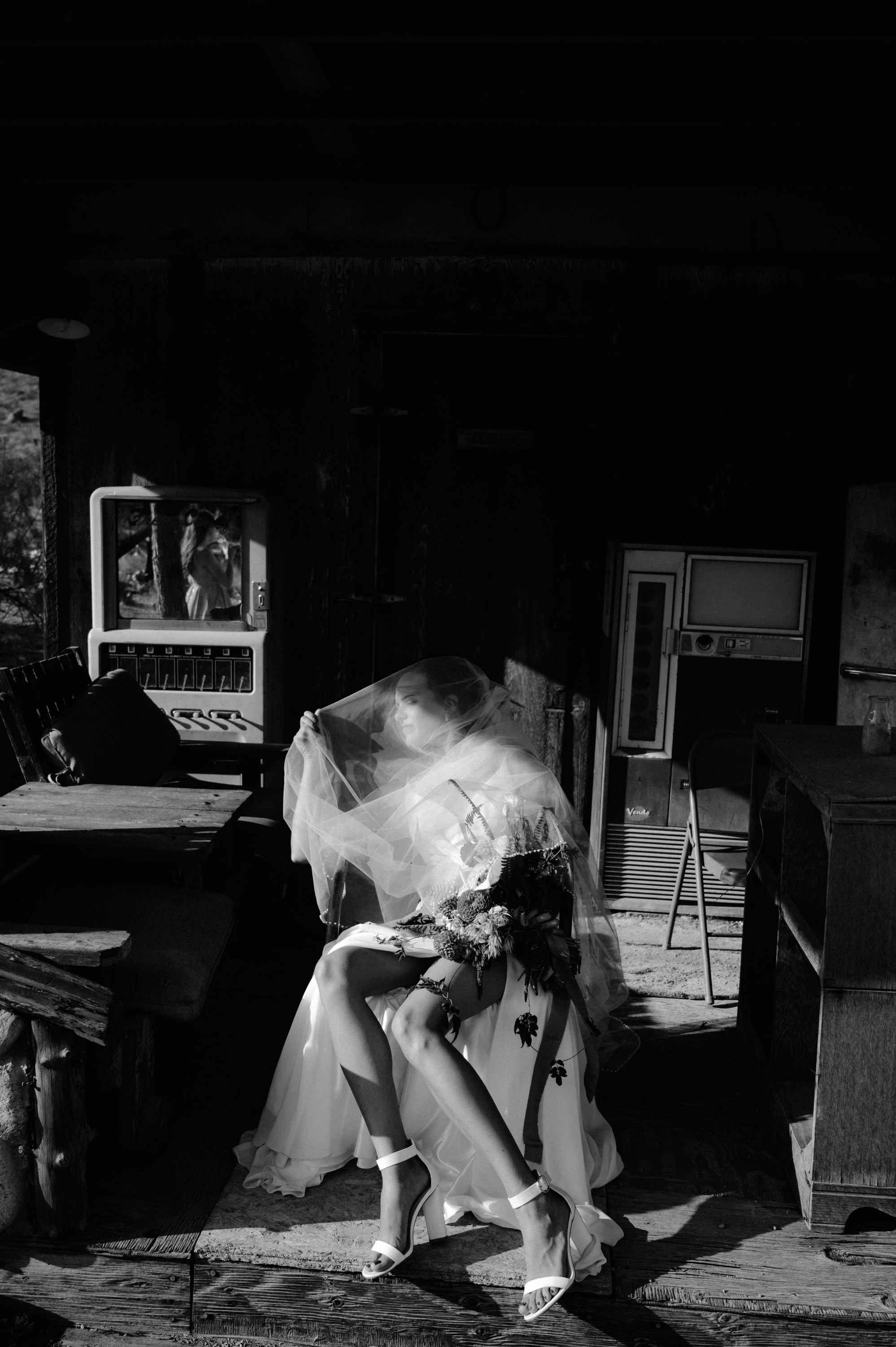 a woman in a white dress is sitting on a chair