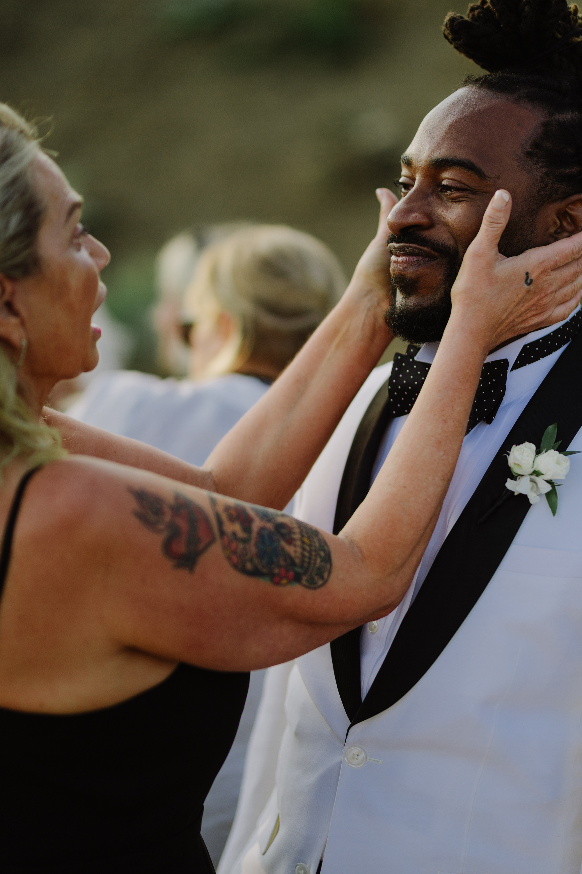a man in a suit and tie fixing his tie