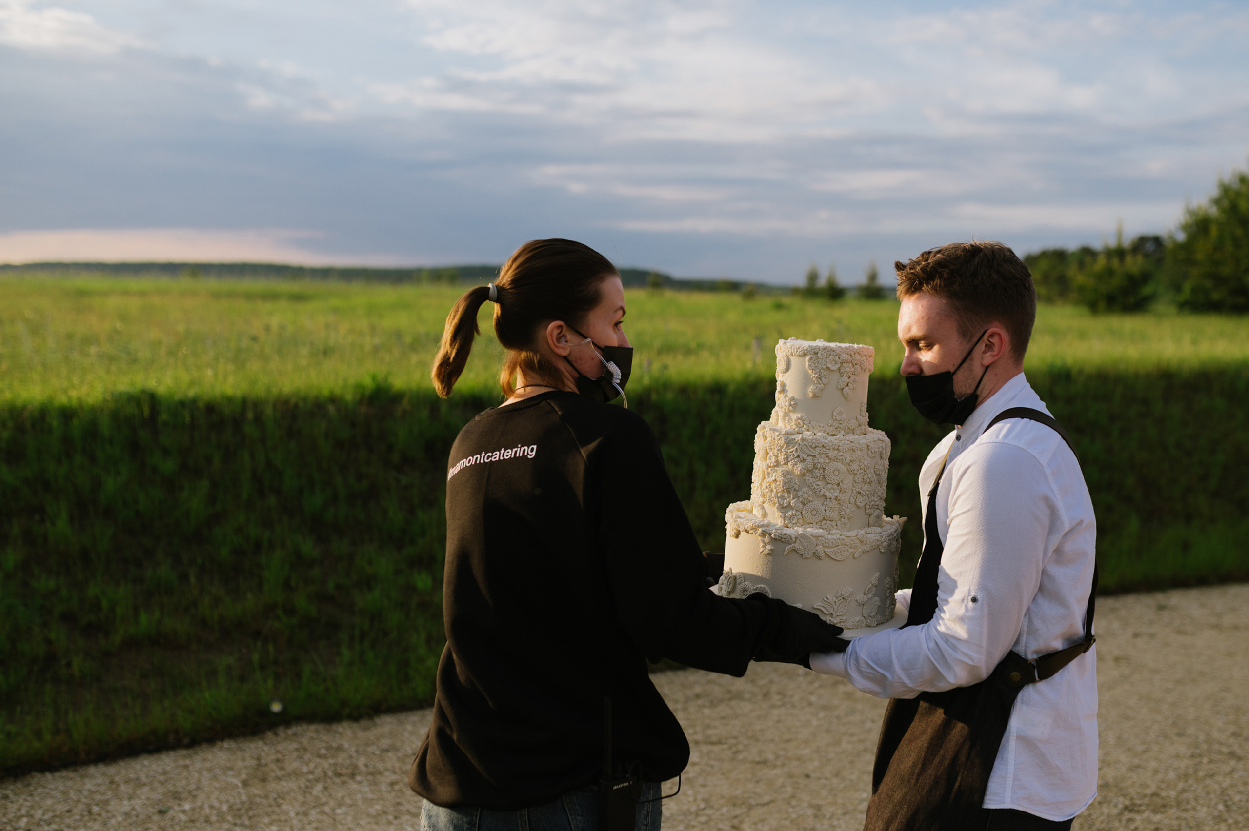 a man and woman holding a cake