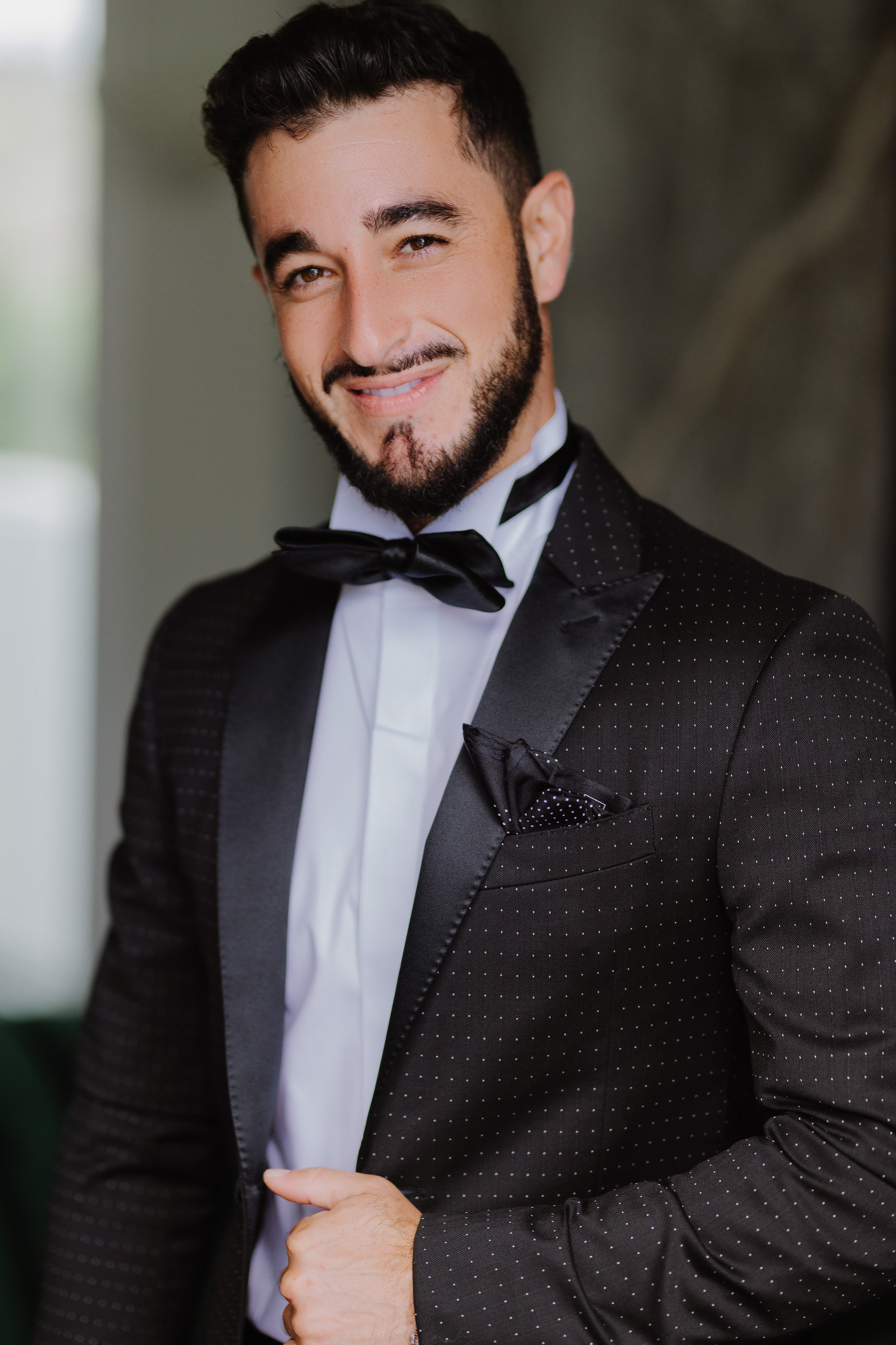 a man in a suit and bow tie