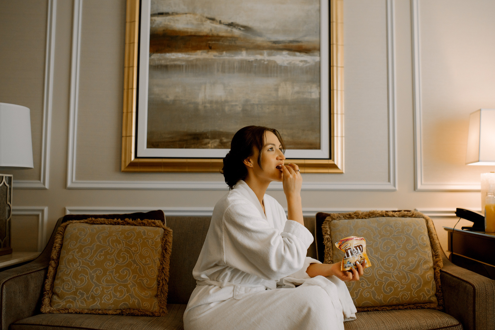 a woman sitting on a couch in a hotel room