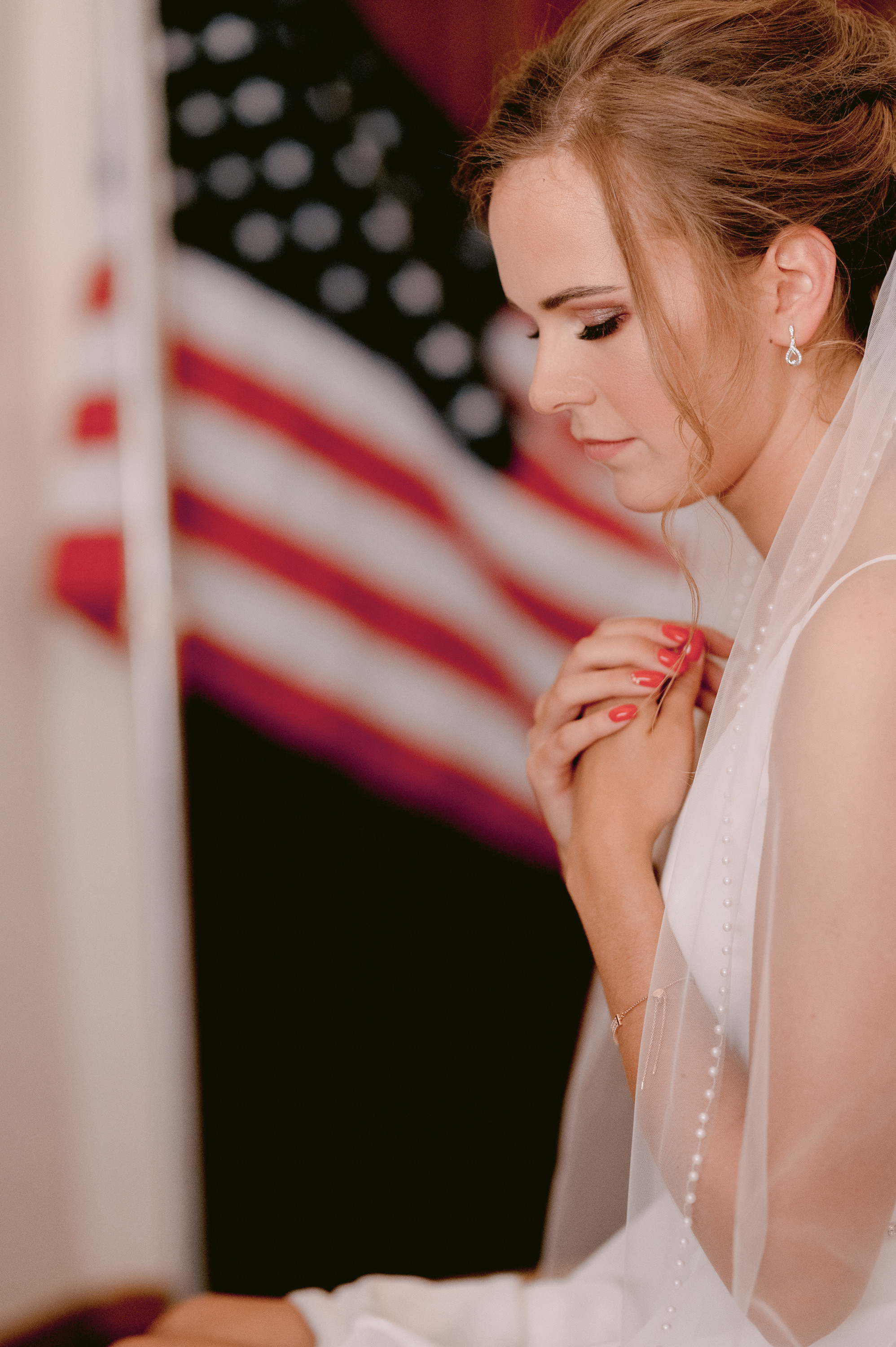 a woman in a wedding dress is putting a ring on her finger