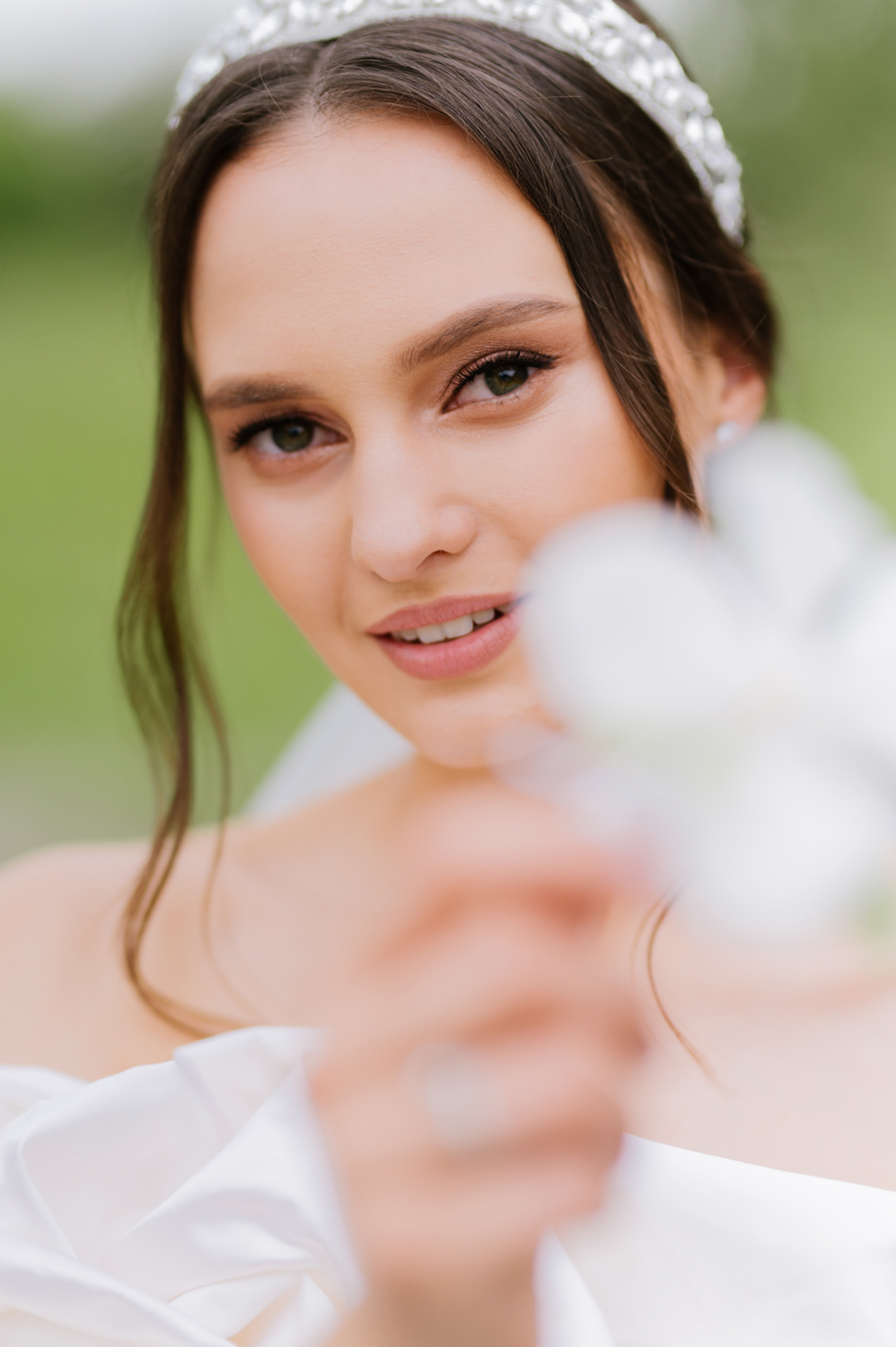 a woman in a white dress holding a flower