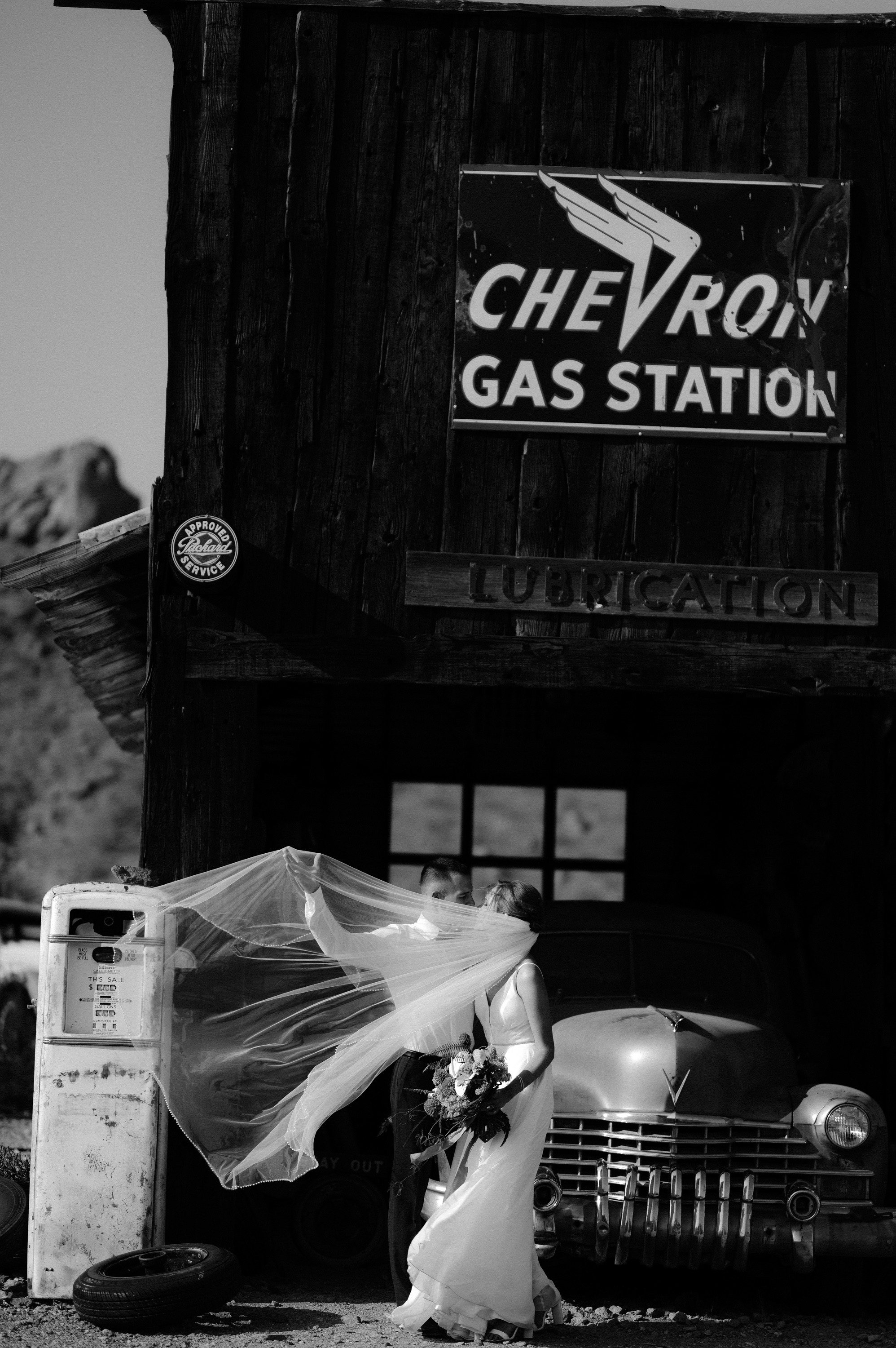 a woman in a dress is standing next to a car
