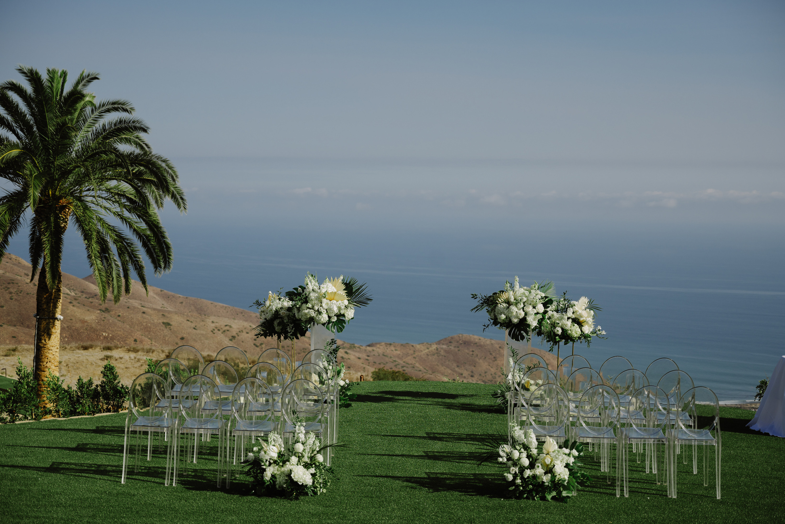 a wedding ceremony set up with chairs and flowers