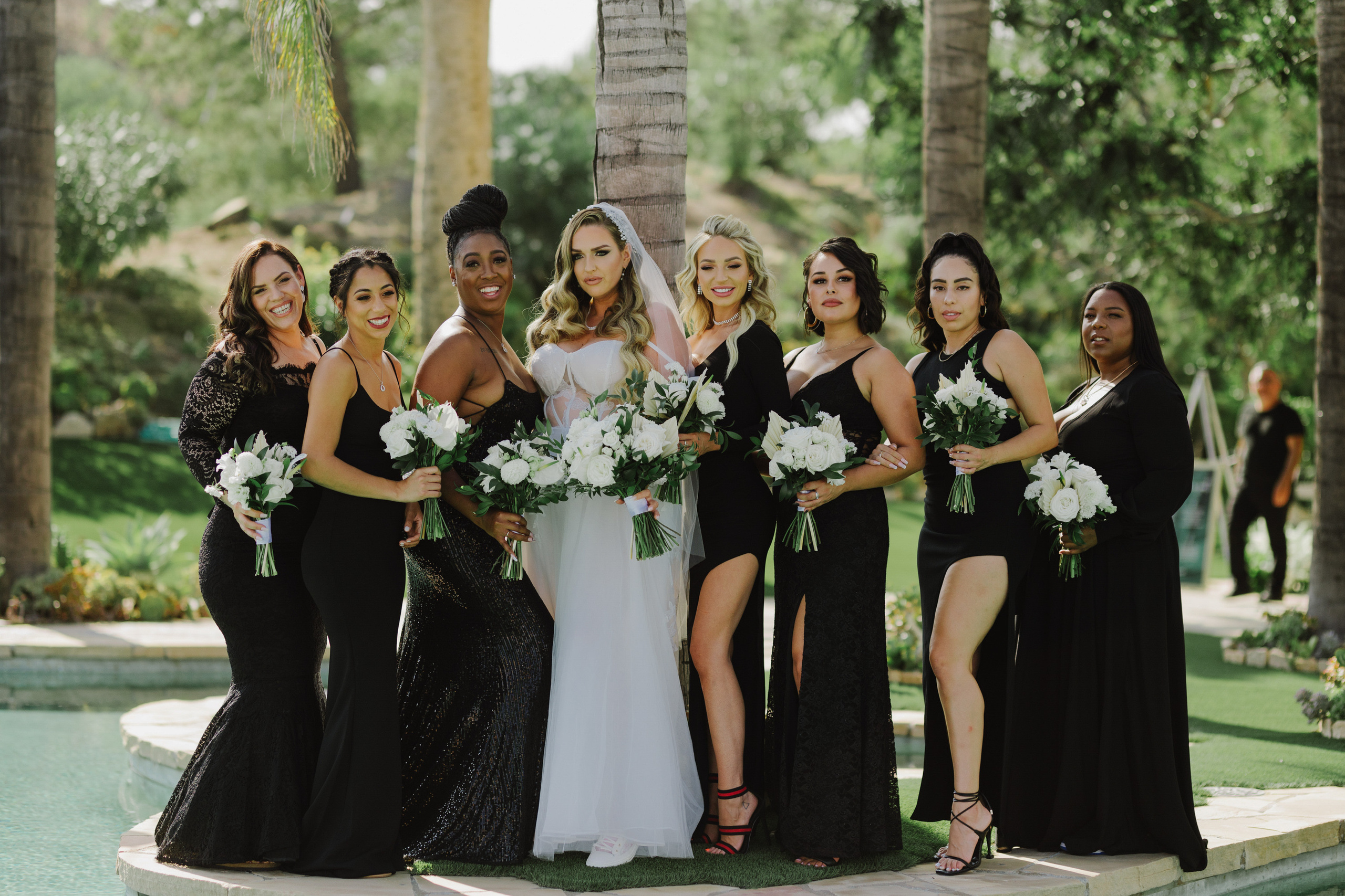 a bride and her bridesmaids pose for a photo
