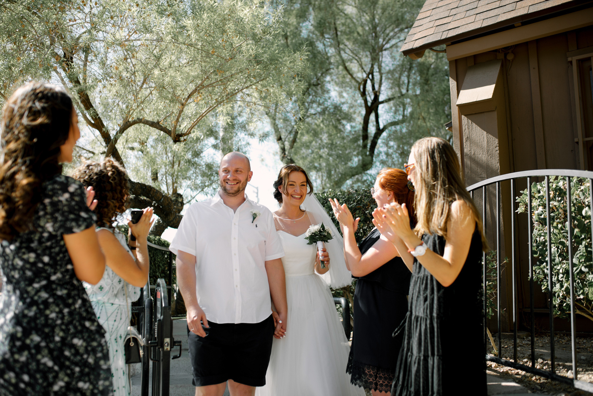 a bride and groom are taking pictures of their wedding party