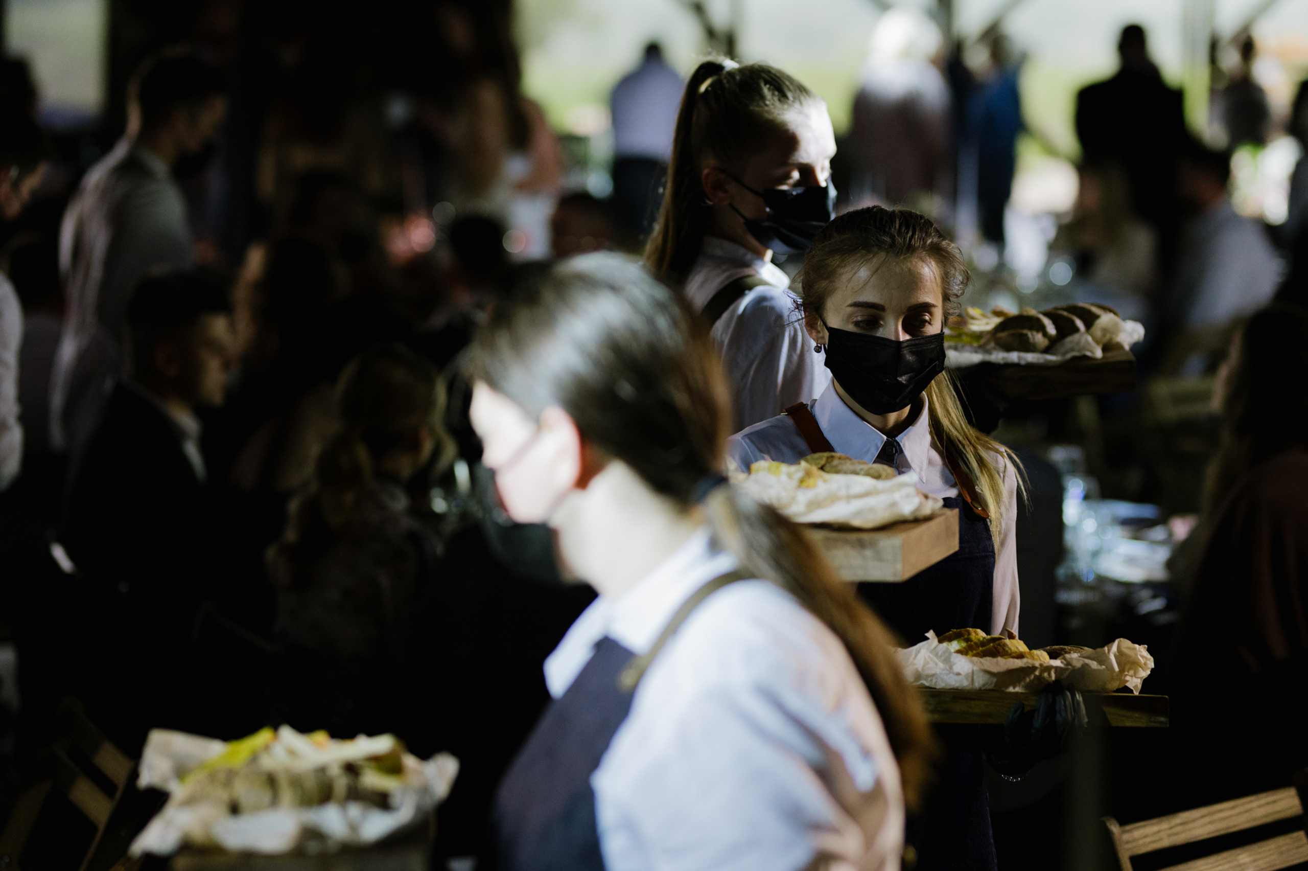 a group of people are eating food at a table