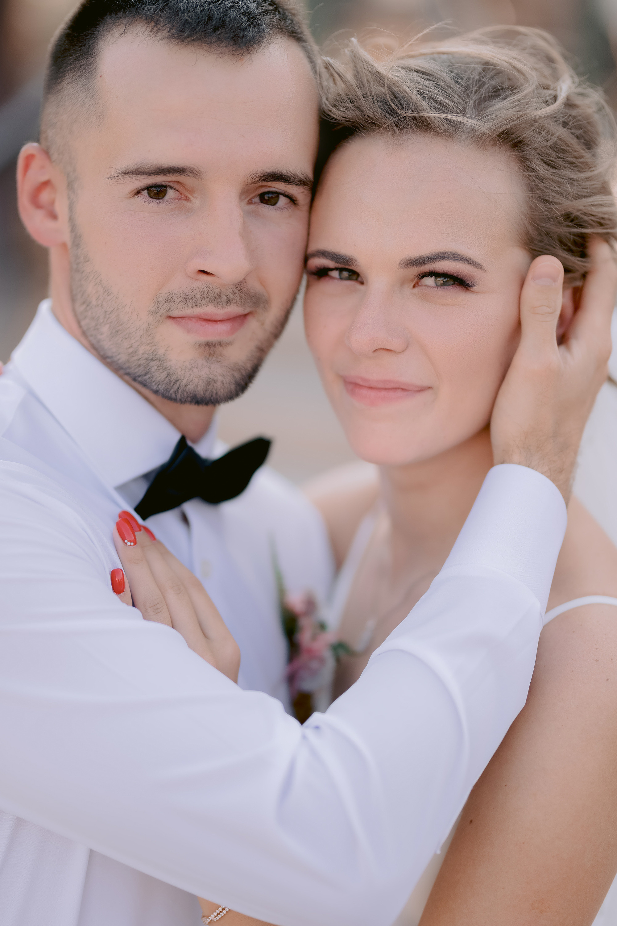 a bride and groom pose for a photo