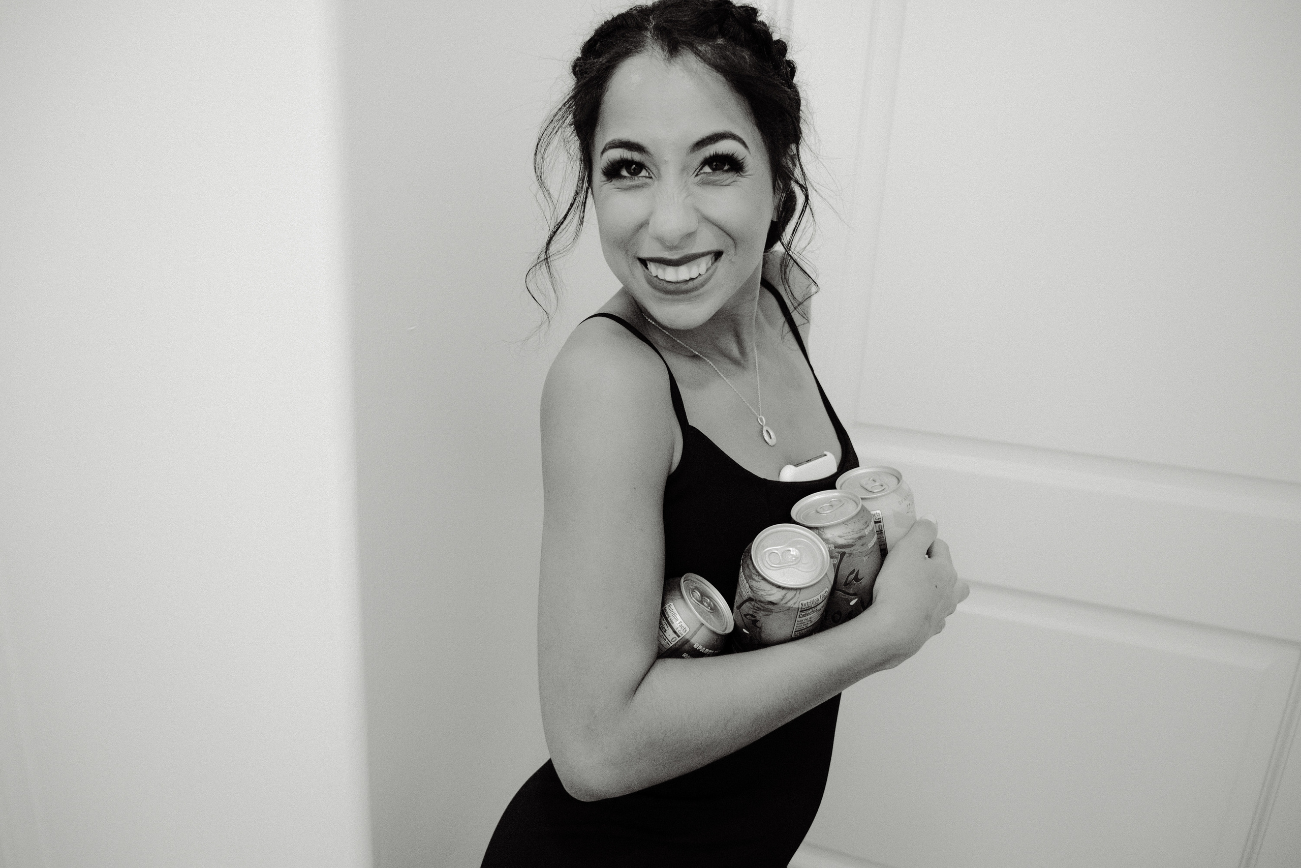 a woman in a black dress holding a cup