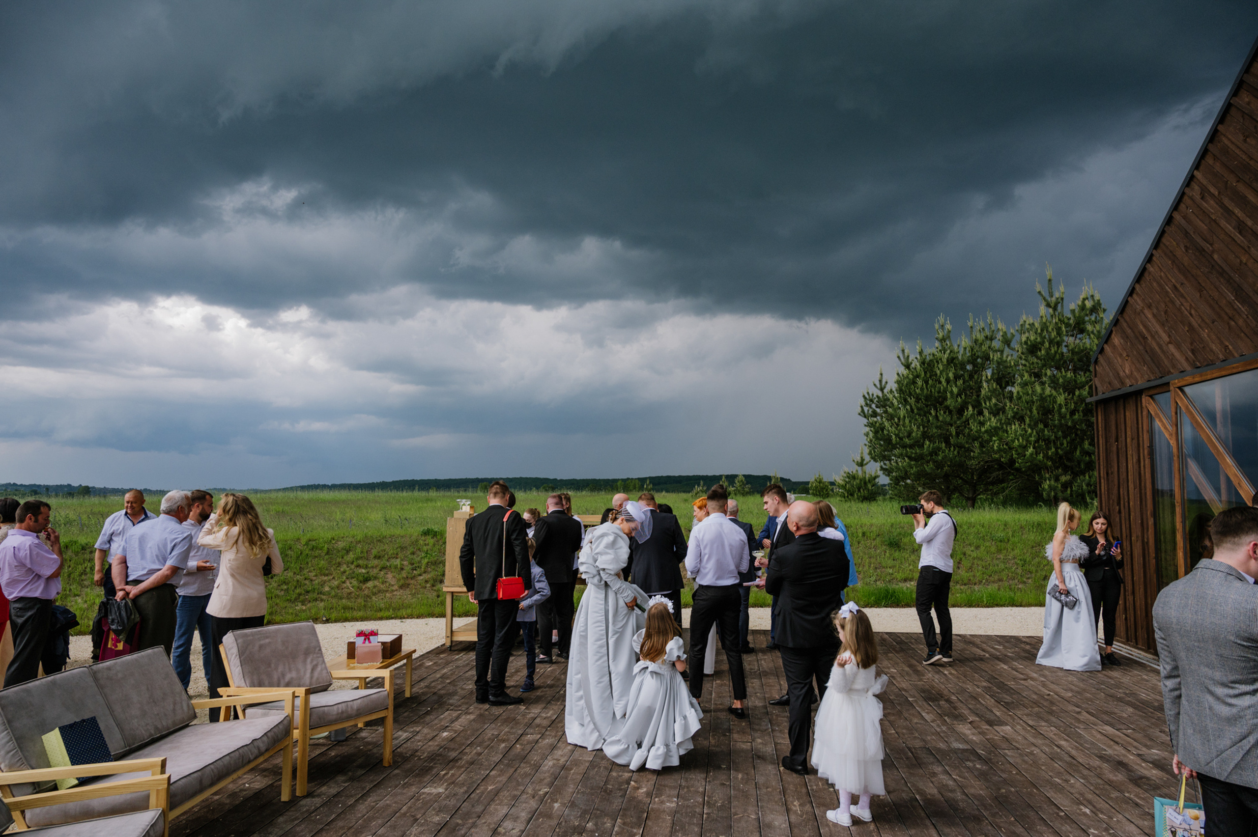 a group of people standing on a wooden deck