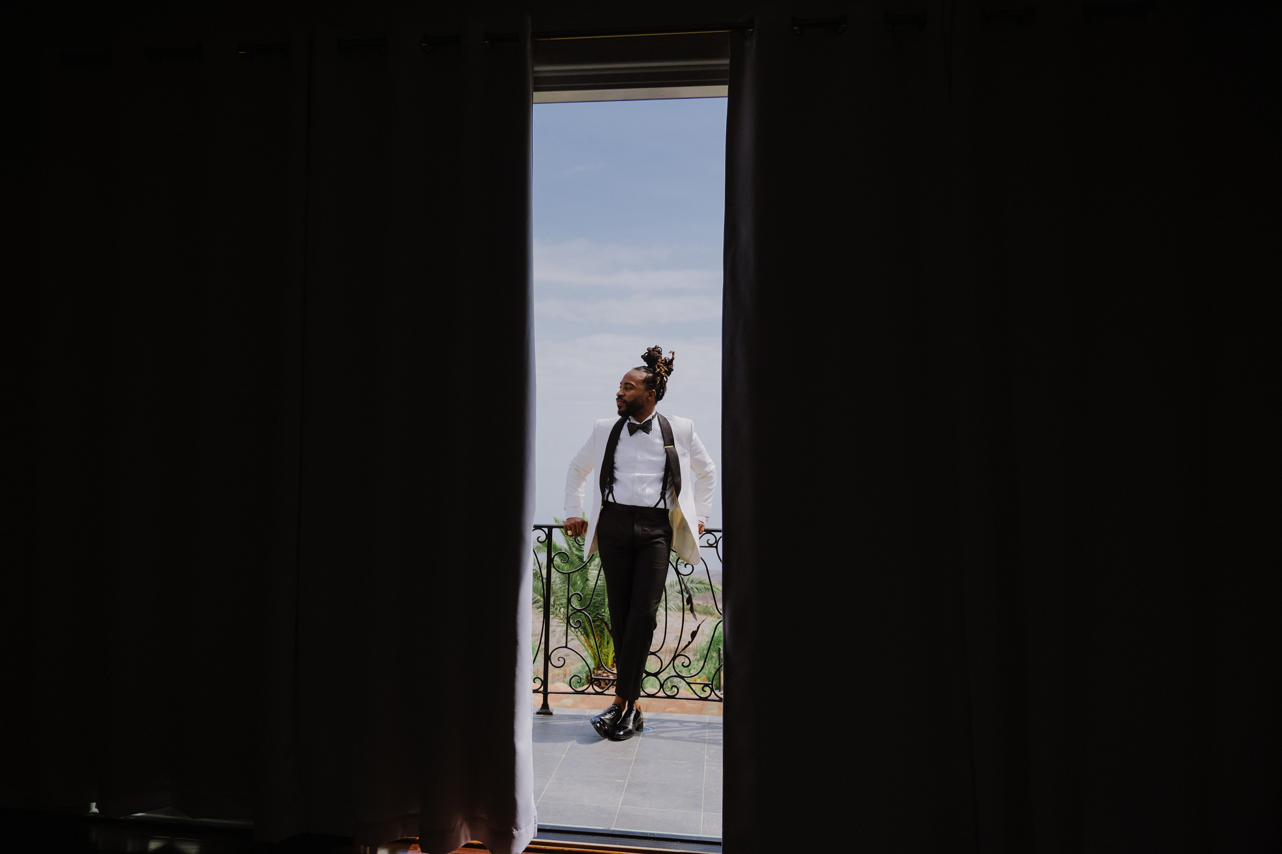 a man in a suit is standing in a doorway